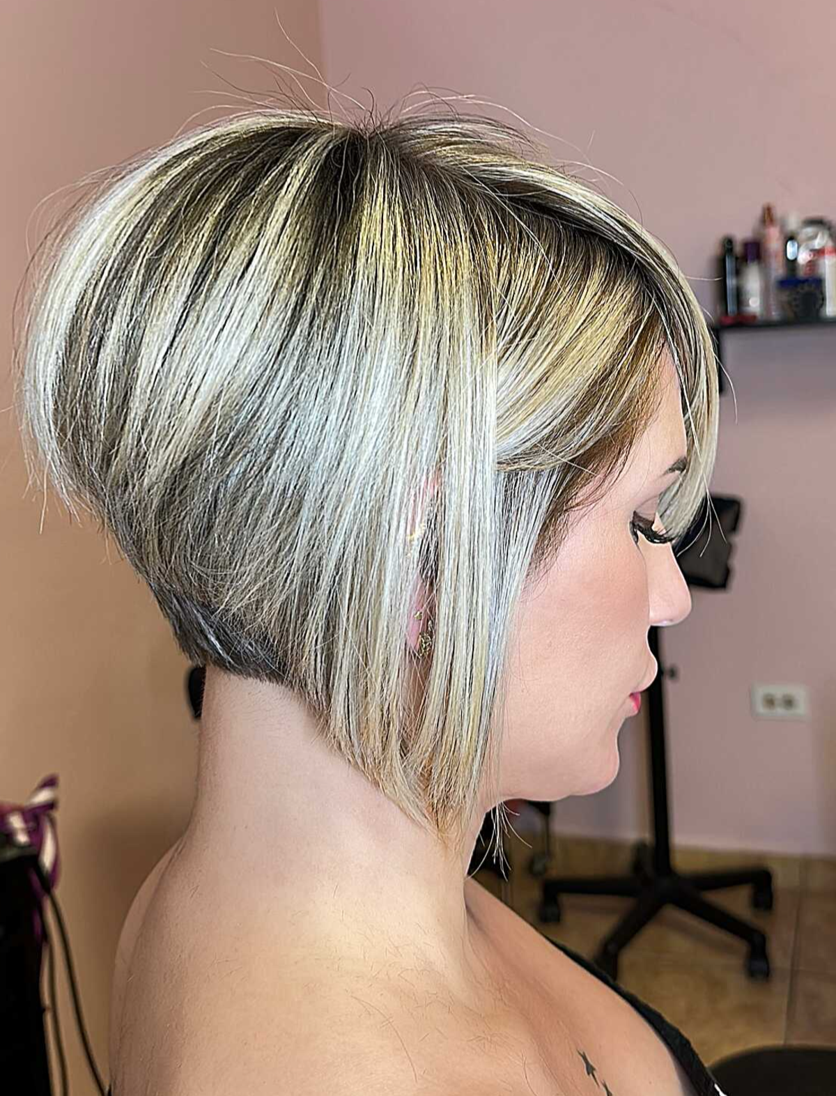 Stacked angled bob with blonde streaks and a lifted crown.