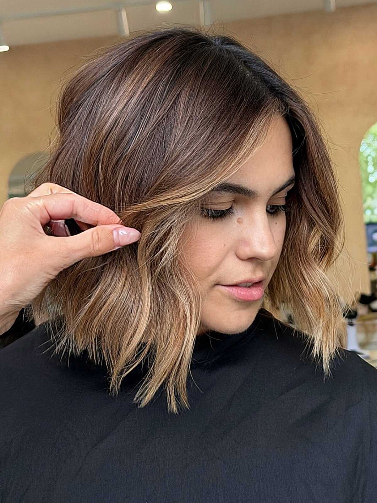 Chin-length textured brown bob with toffee lowlights.