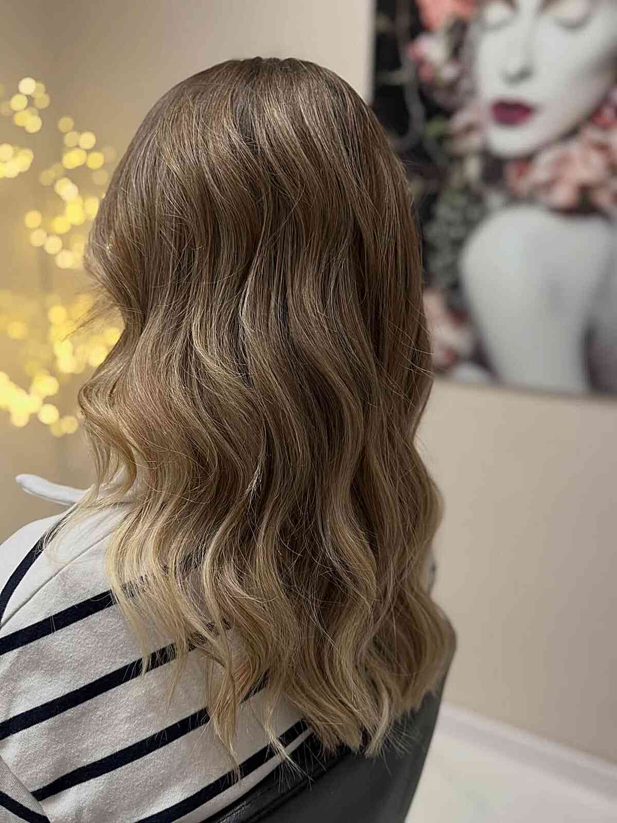 Medium-length wavy hair with balayage and soft contrast.
