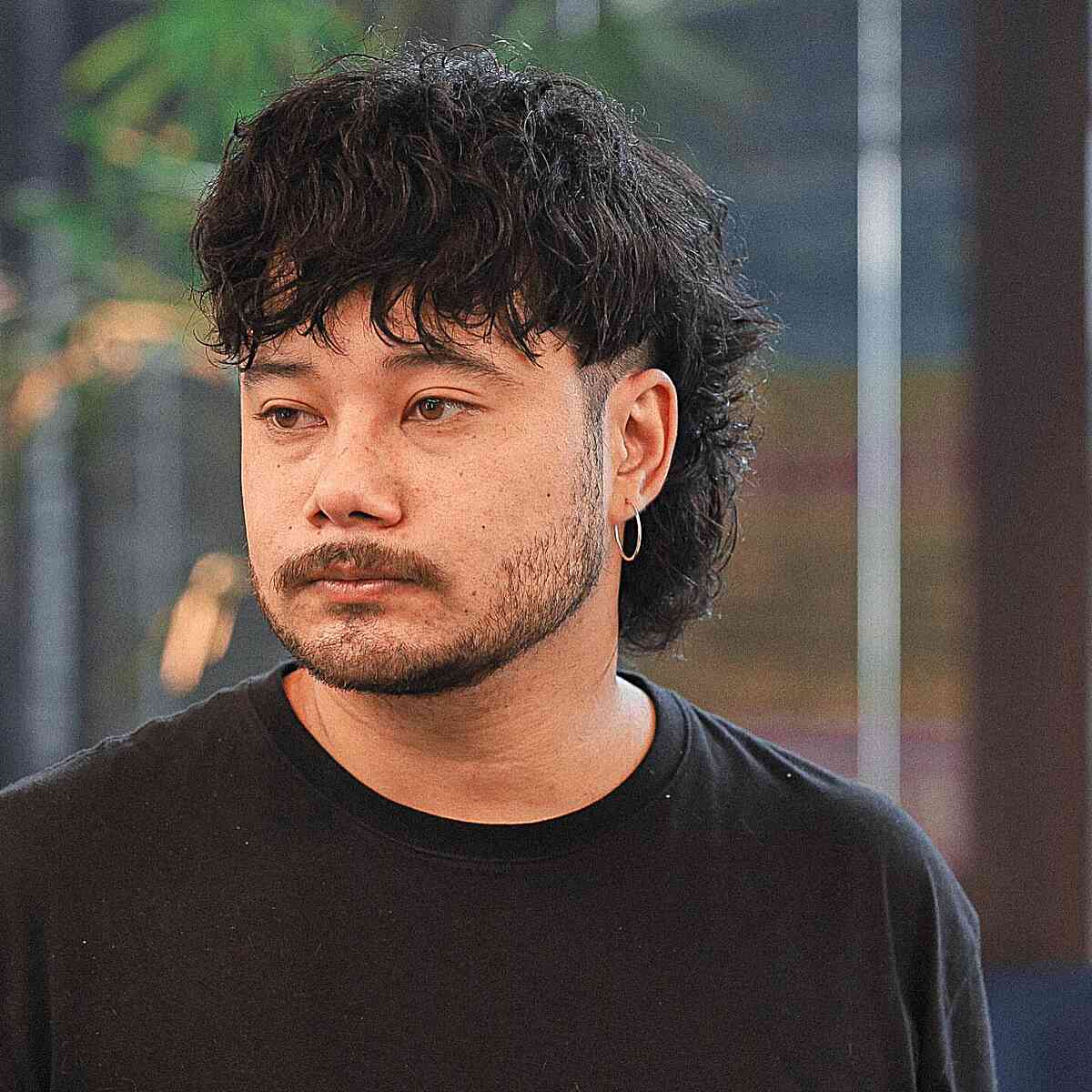 Short mullet with textured fringe, close sides, and longer back.