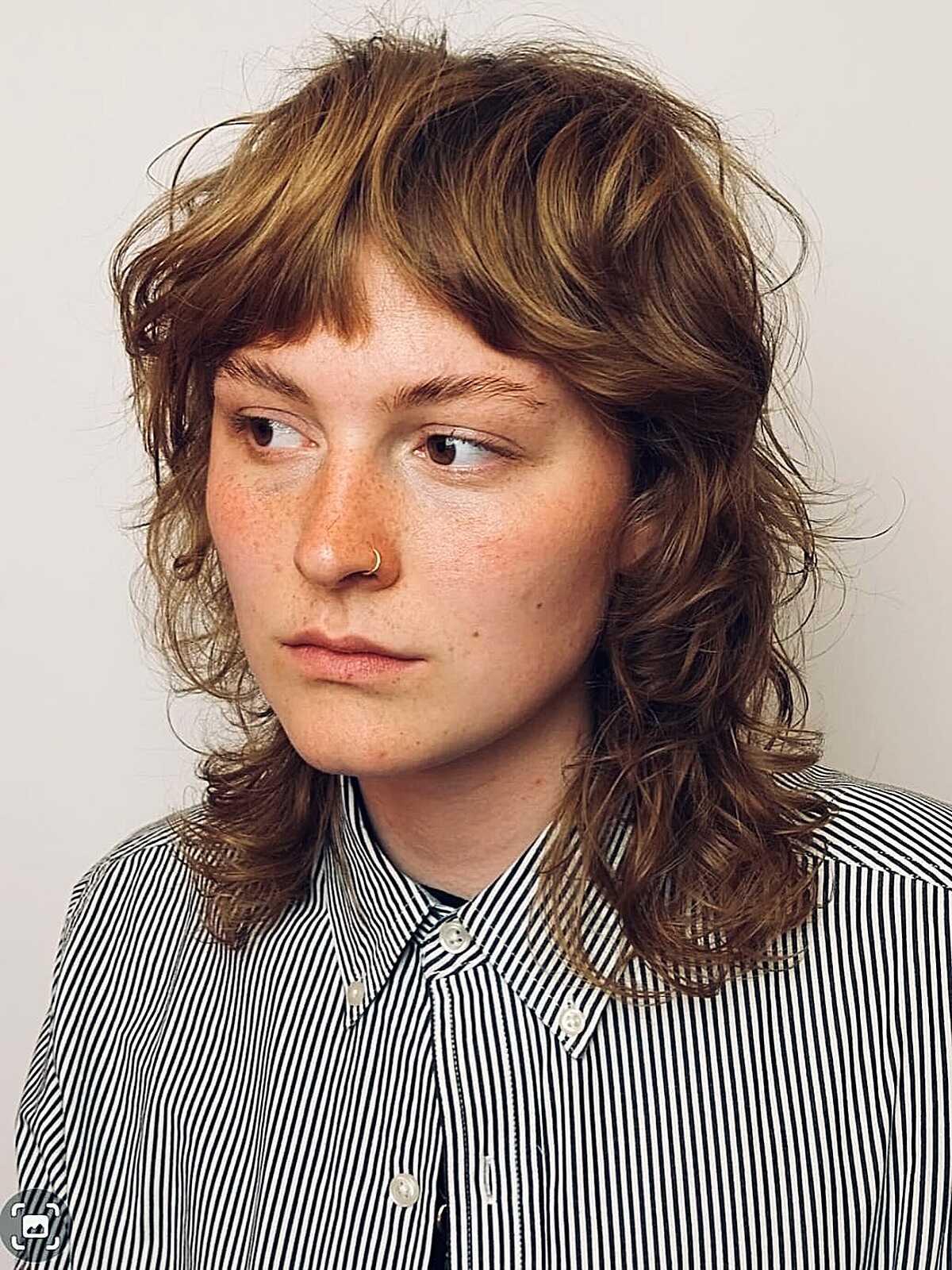 Caramel wavy shag with visible texture and layered fringe.