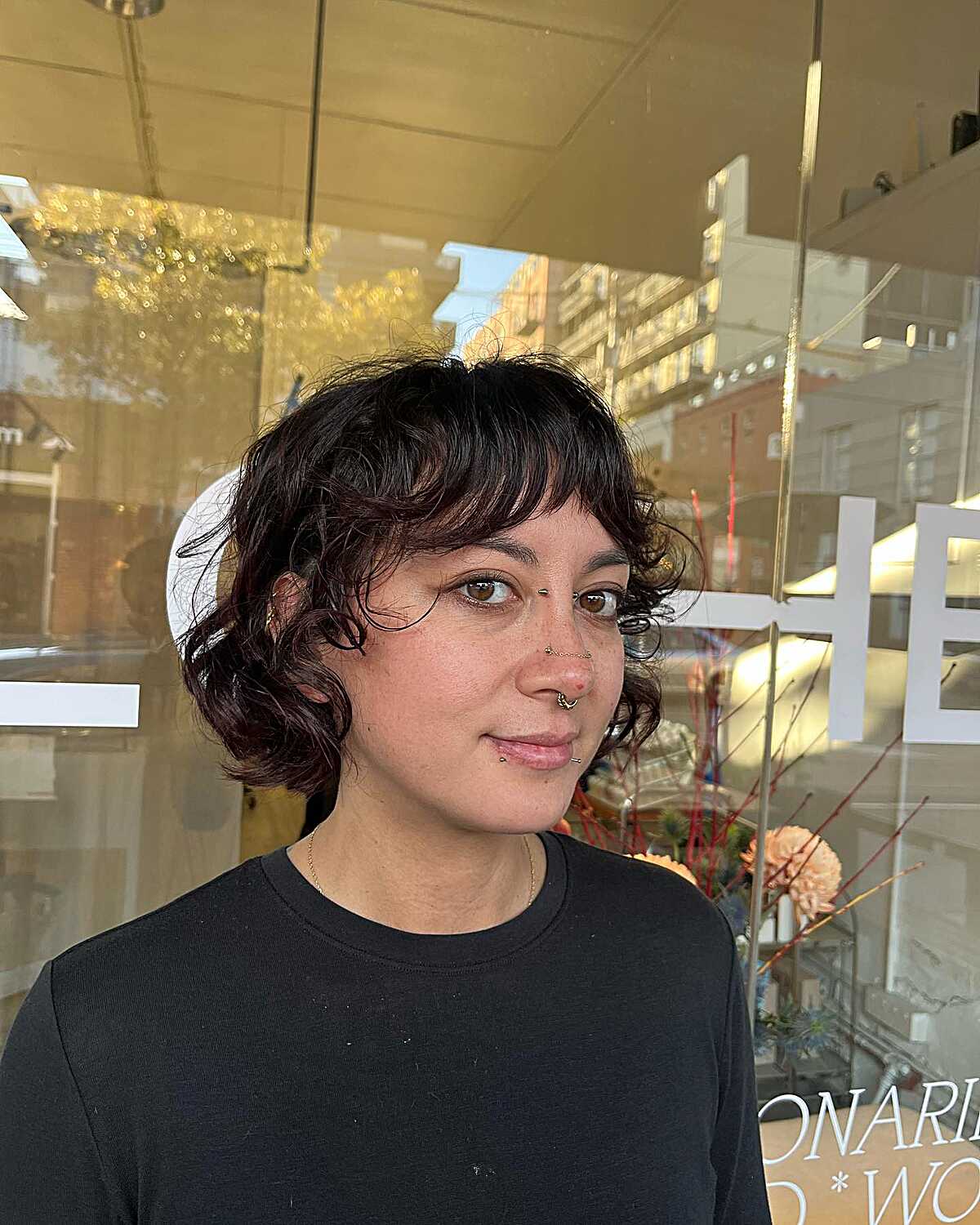 Dark curly bob with a short fringe and rounded shape