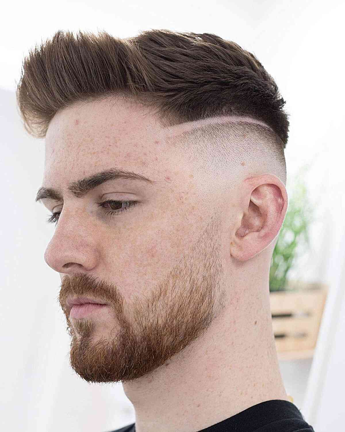Brushed-up short top with a shaved line and faded sides.