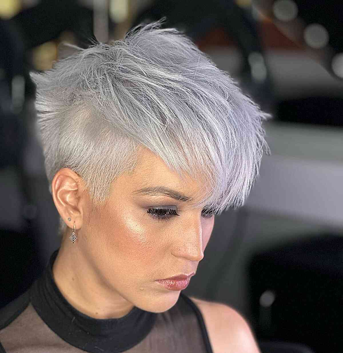 Silver pixie with side-swept fringe and closely cropped sides.