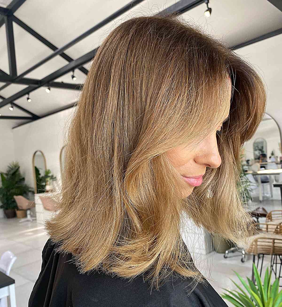 Shoulder-length bronde bob with rounded ends and a soft side sweep.