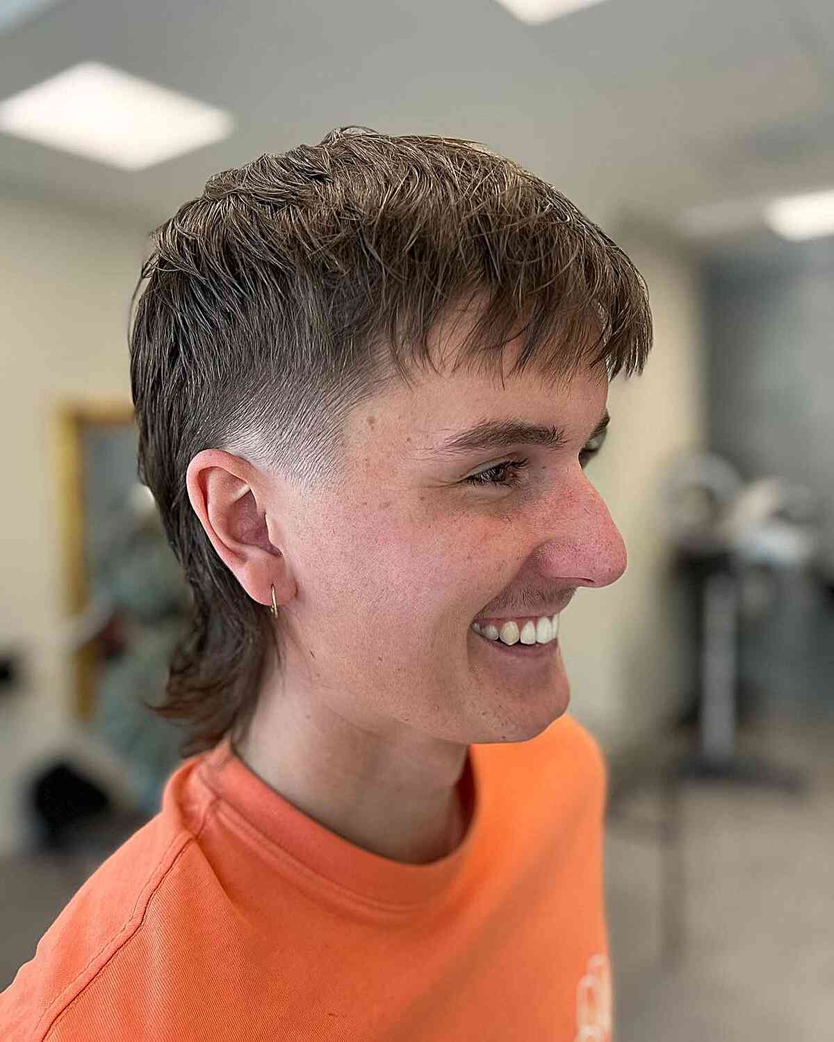 Short mullet with straight fringe, faded sides, and longer back.