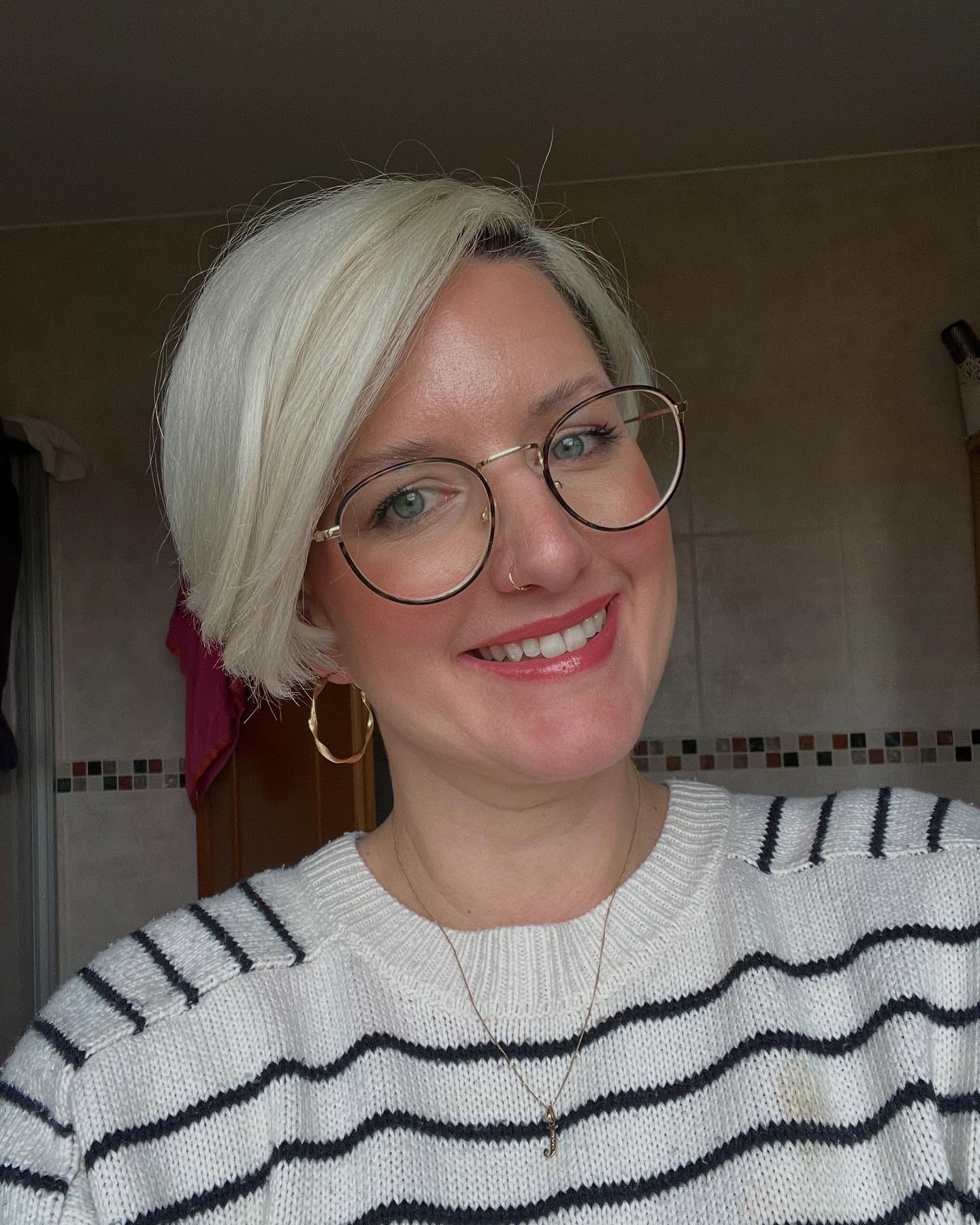 Platinum pixie with side-swept front and short nape.