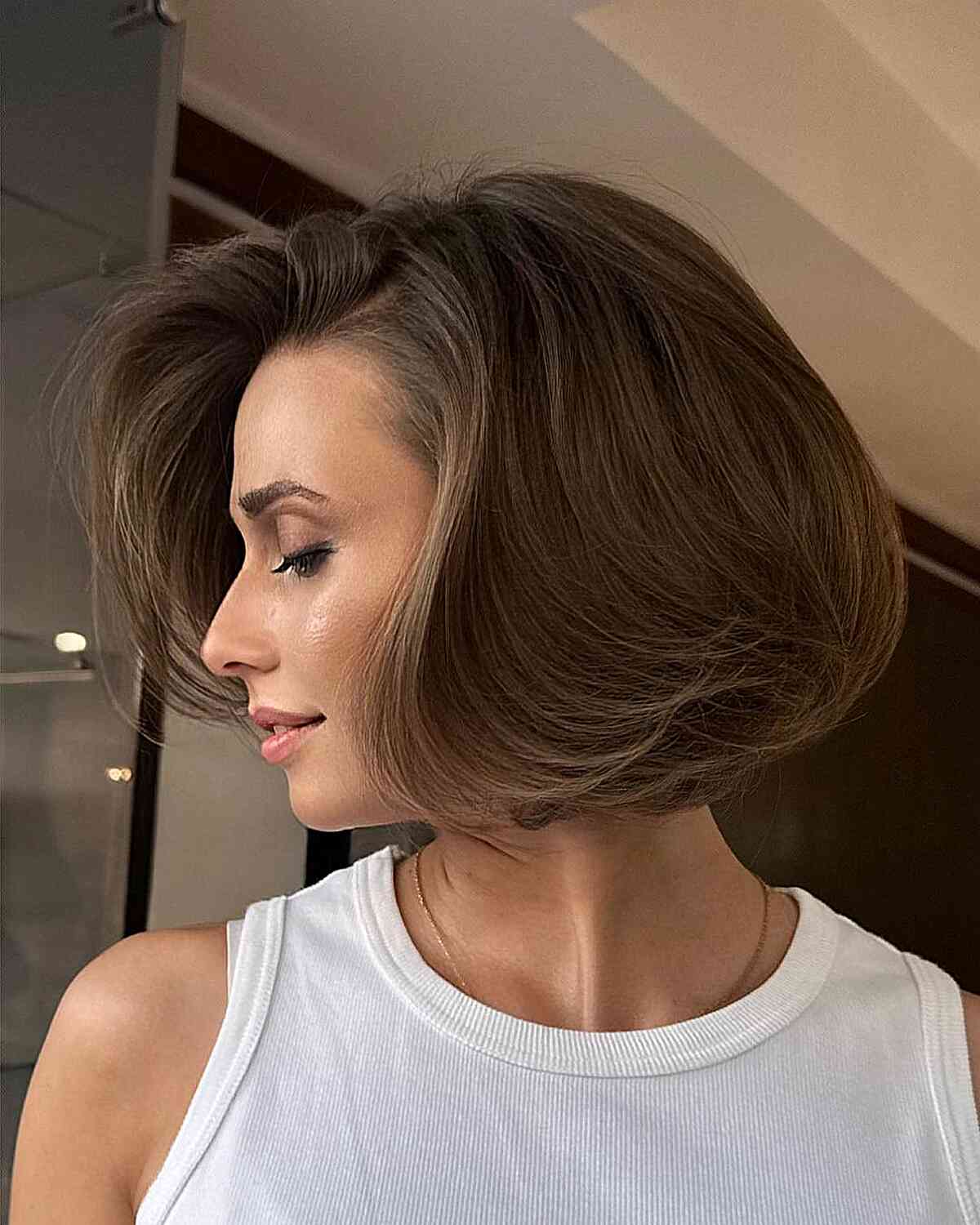 Rounded side-parted brown bob with smooth volume