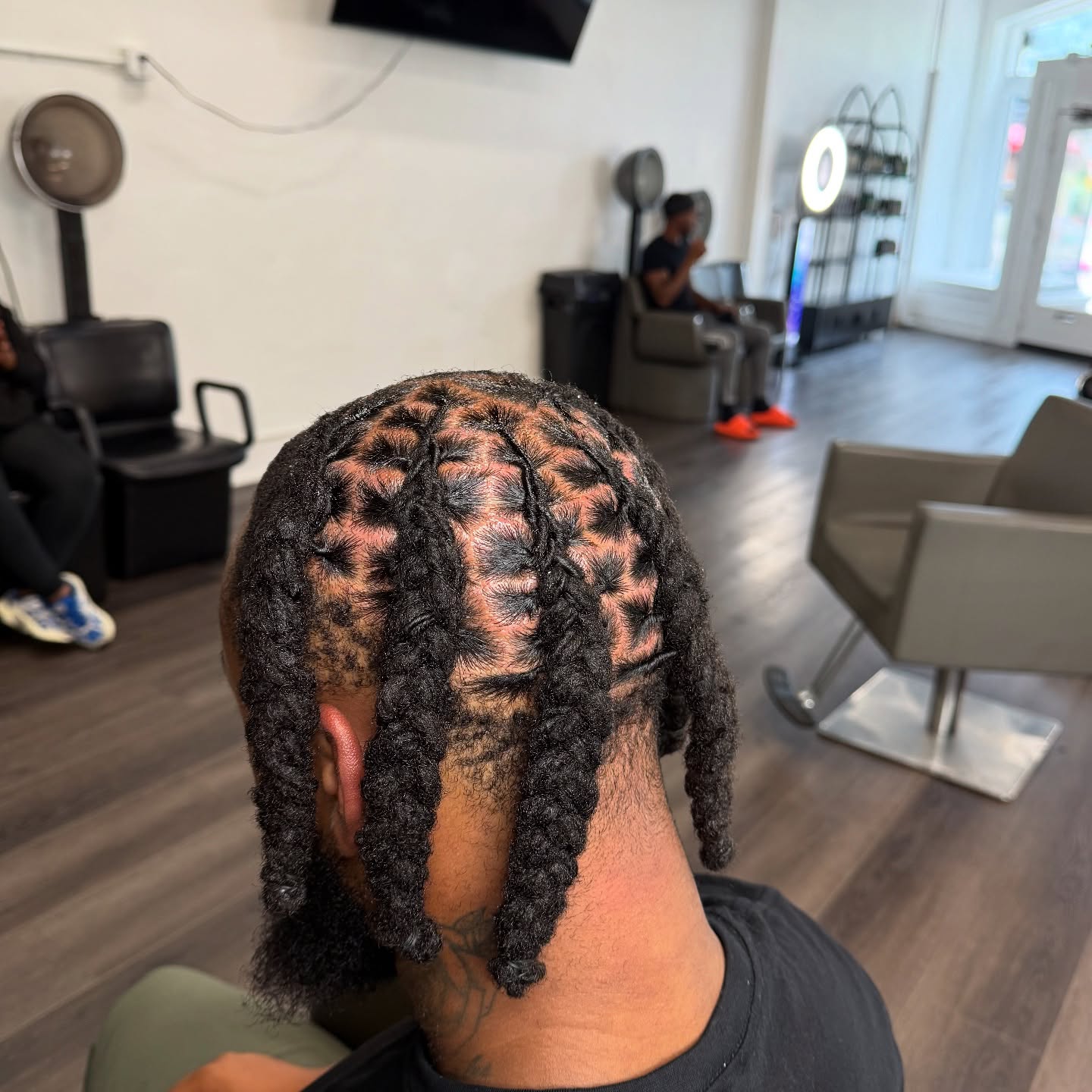 Short twisted dread sections arranged in a rounded crown pattern.