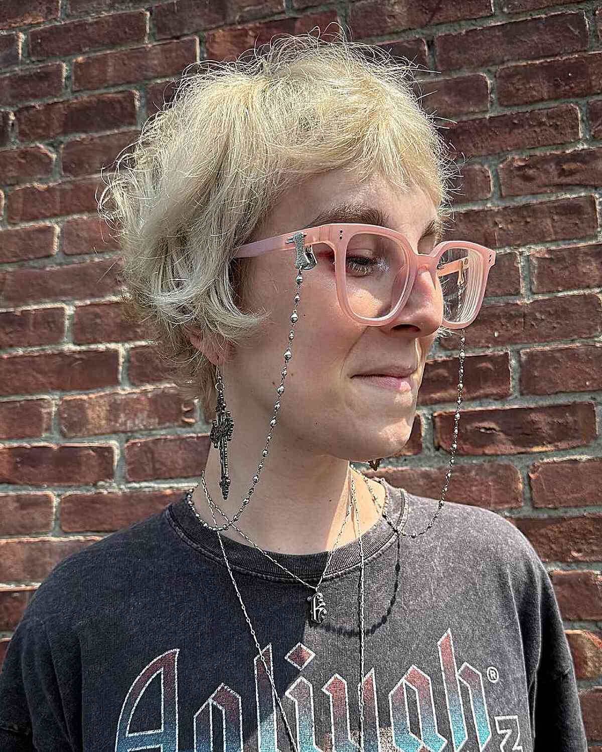 Tousled platinum pixie with feathered layers and short fringe.