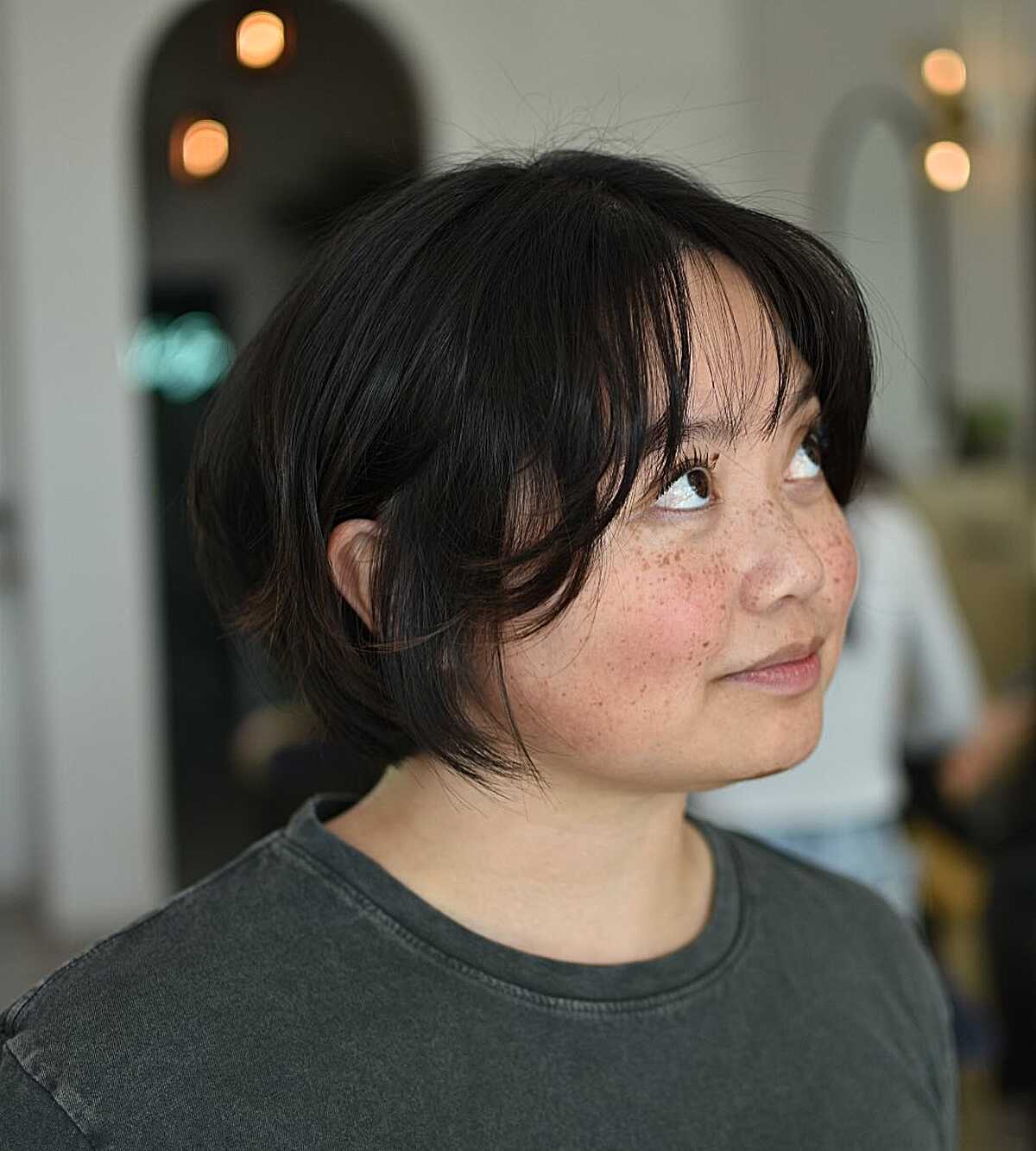 Short black bob with piecey bangs and soft textured ends