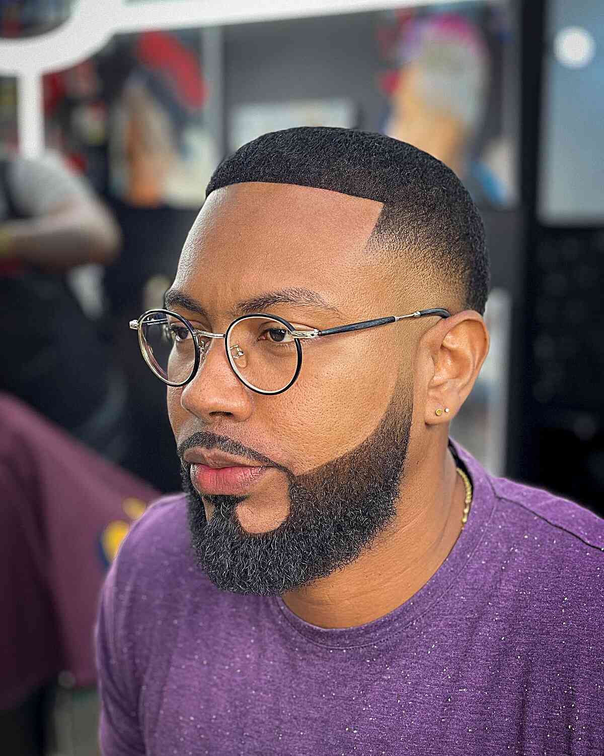 Short top with a boxed beard and tight fade at the sides.