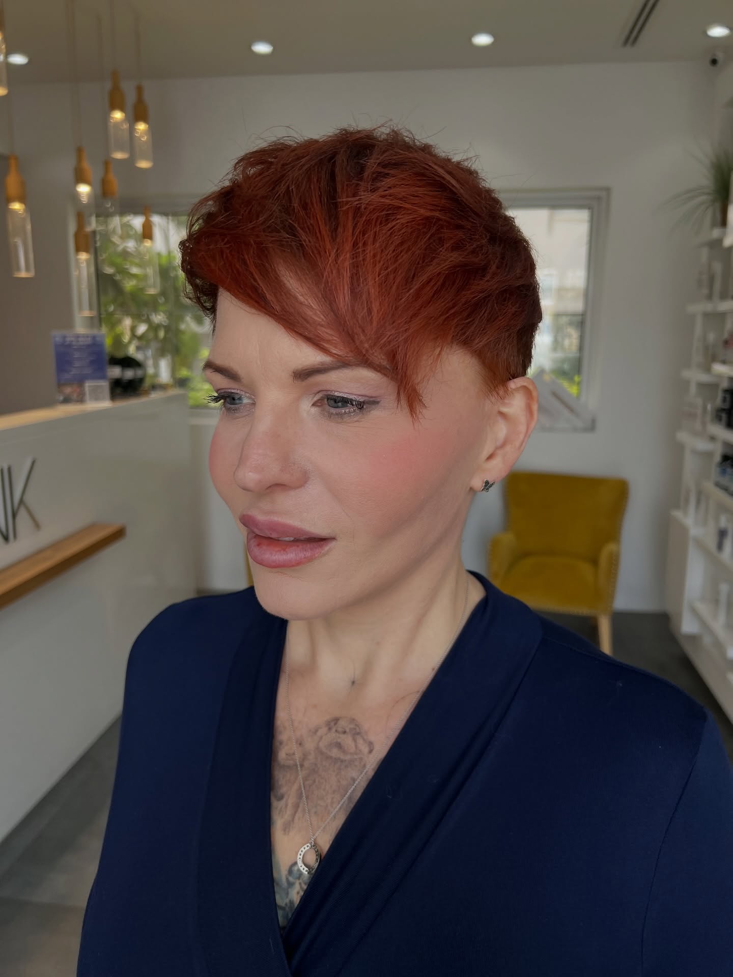 Copper asymmetrical pixie with long side fringe and short nape.