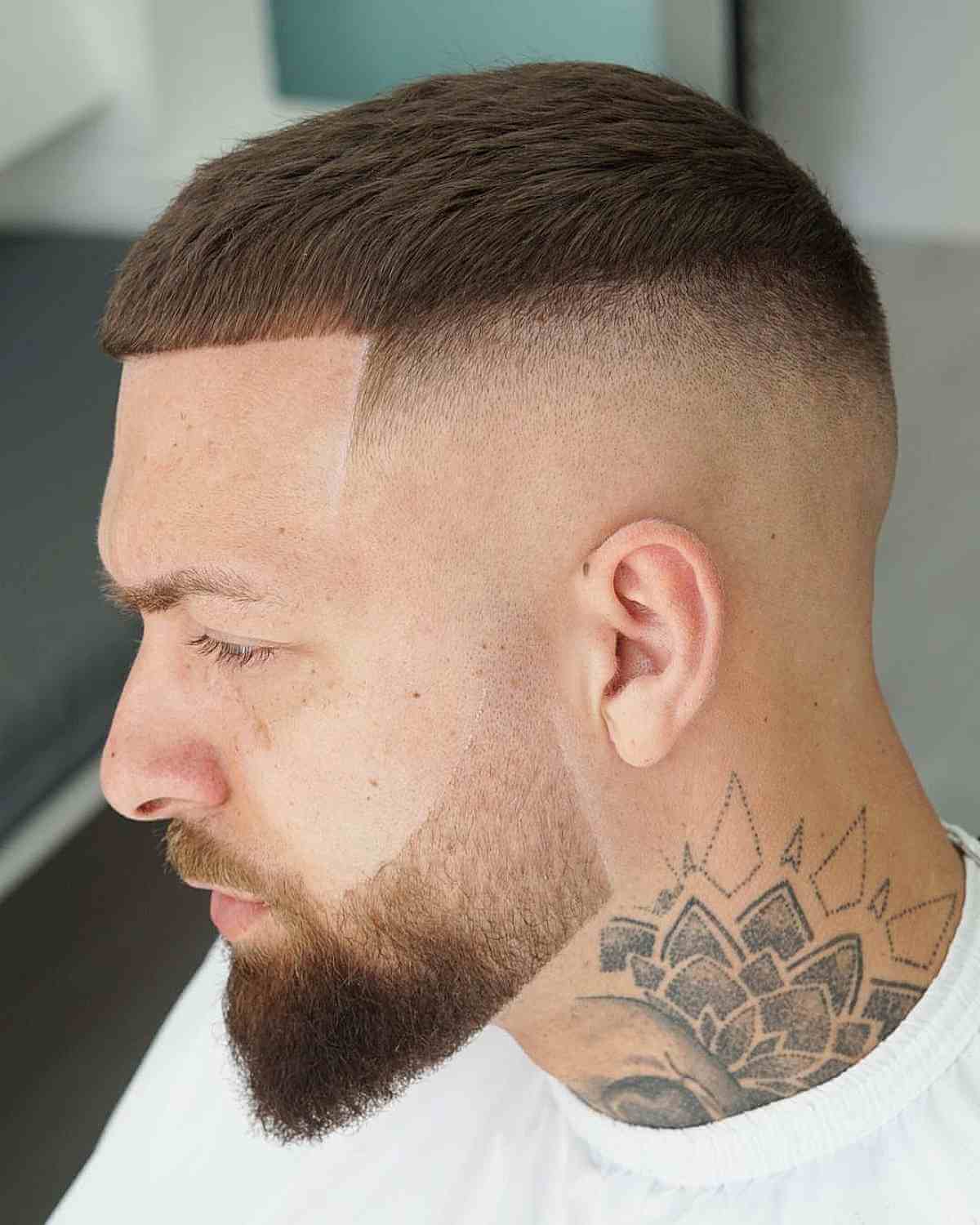 Compact fringe with a high skin fade and short top.