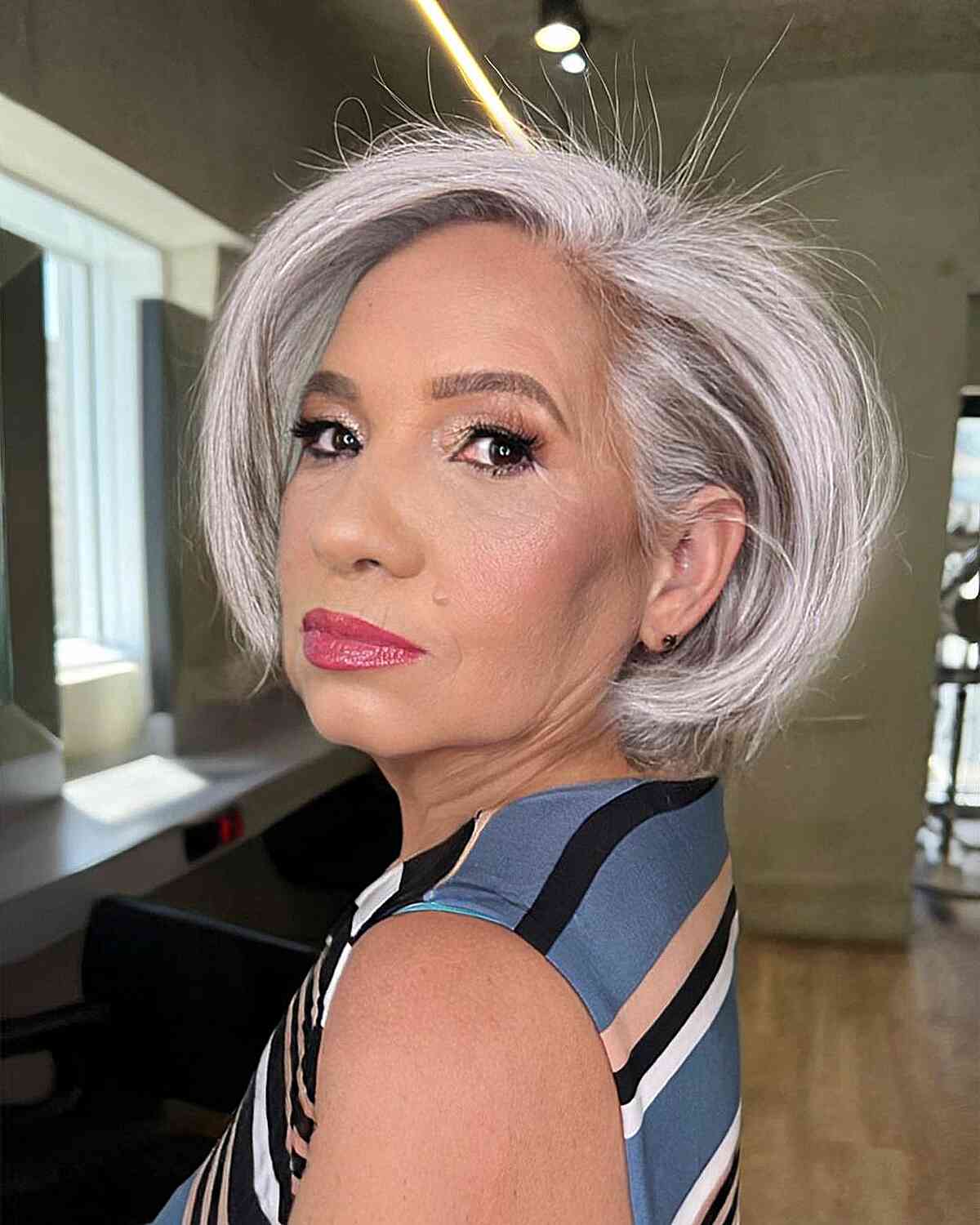 Platinum bob with side-swept layers and rounded ends.