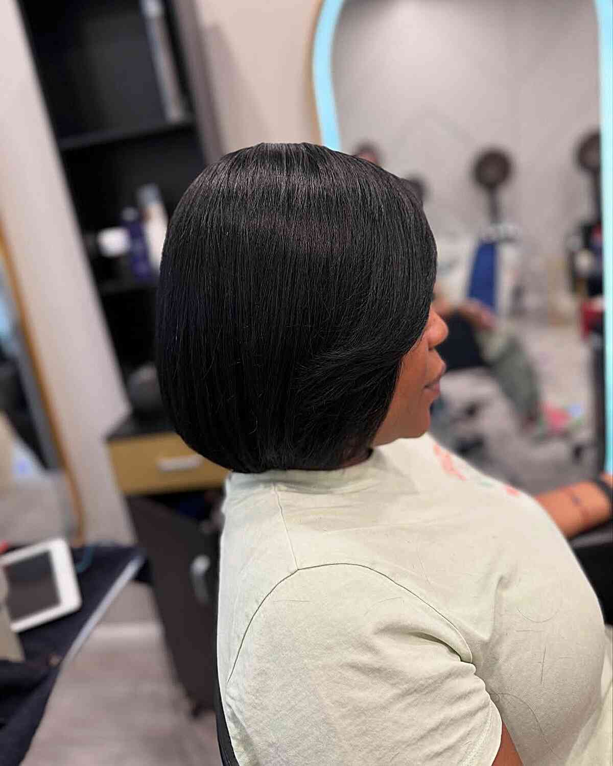 Smooth chin-length blunt bob with rounded ends.