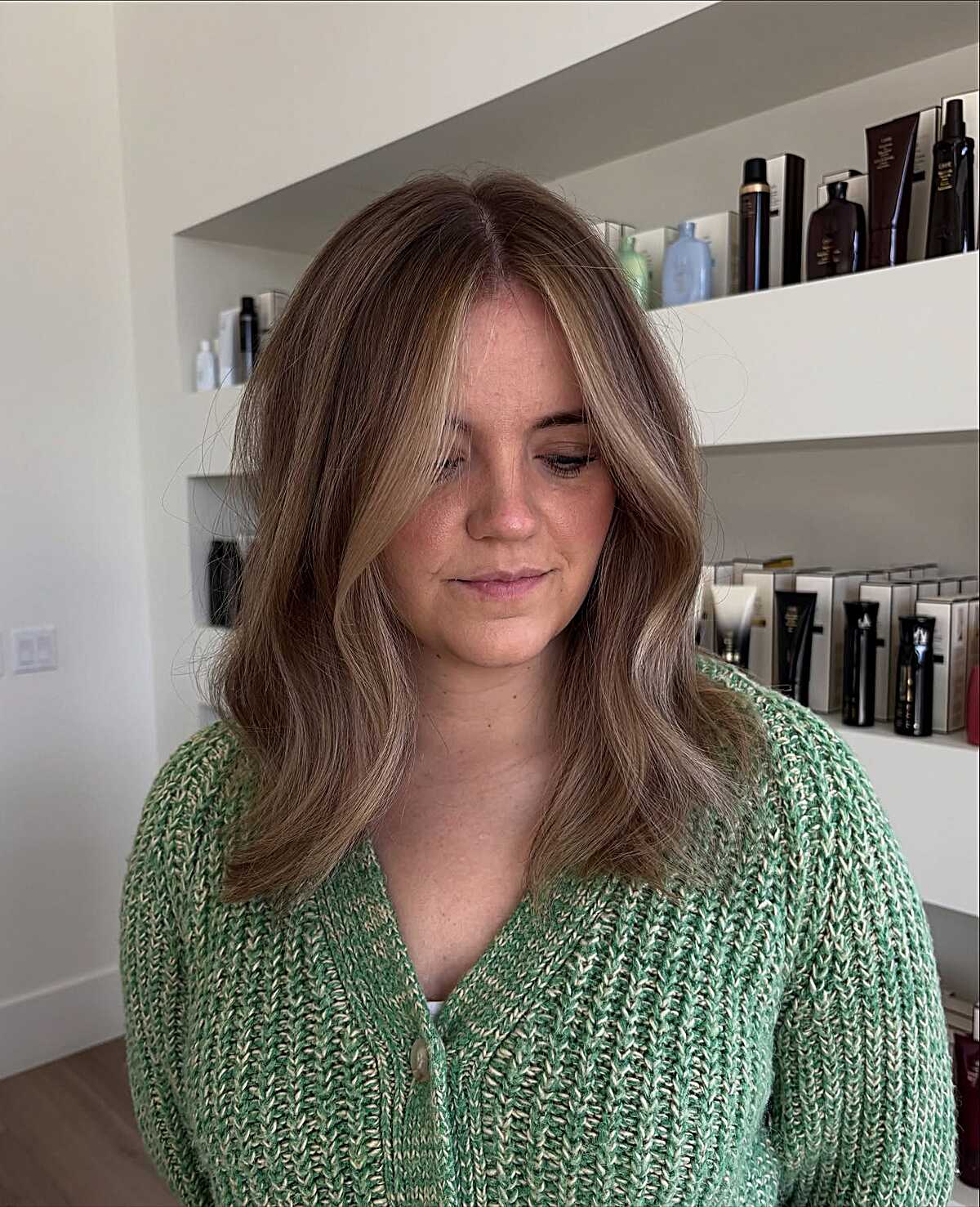 Medium mushroom brown hair with subtle cool lowlights.