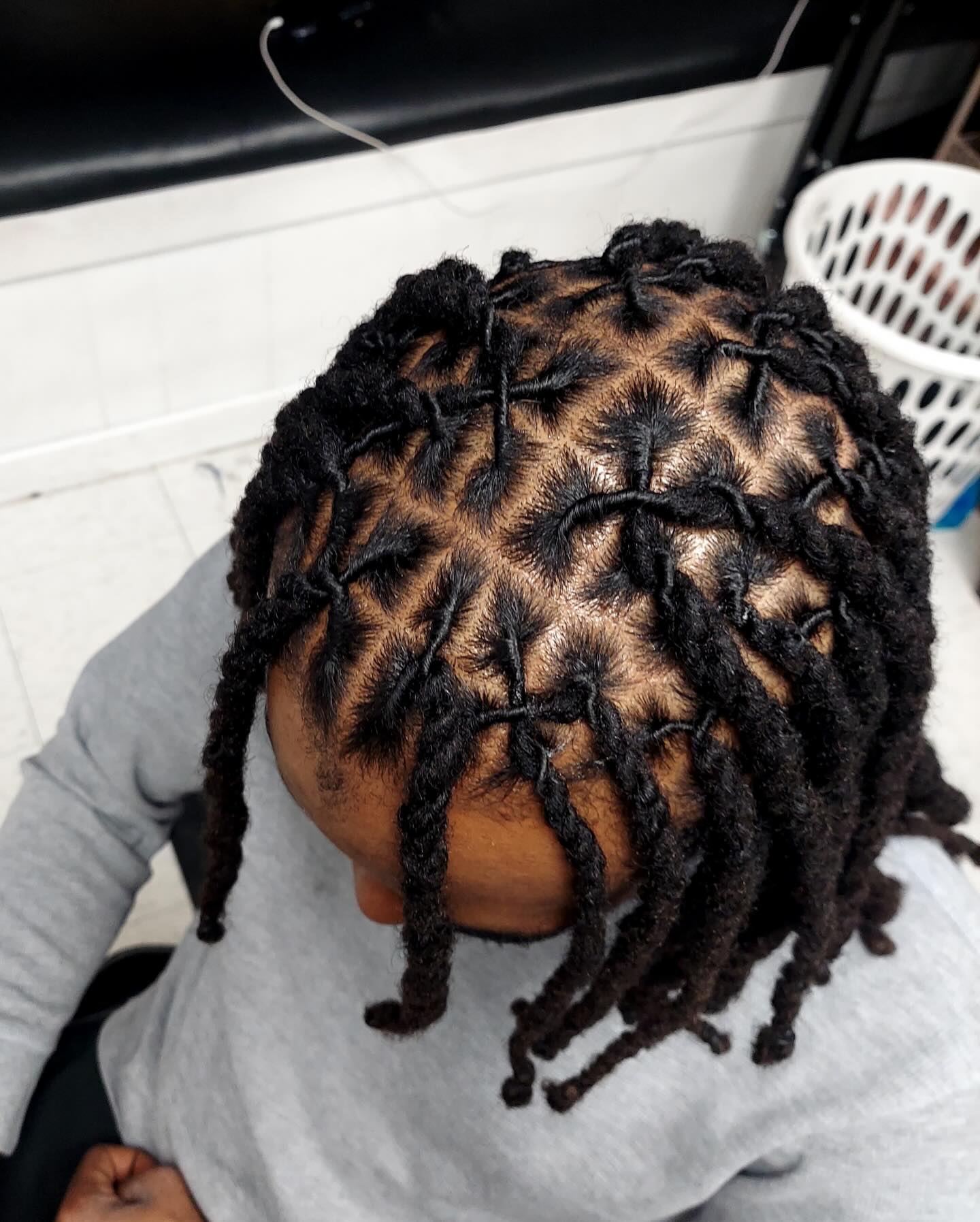 Short dread twists with neat parting and visible scalp sections.
