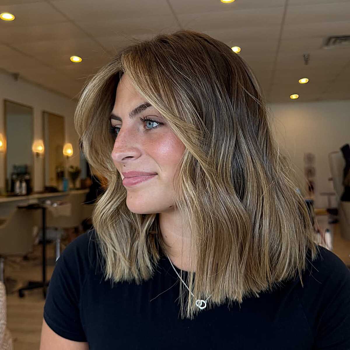 Shoulder-length lob with blonde face frame and brown lowlights.