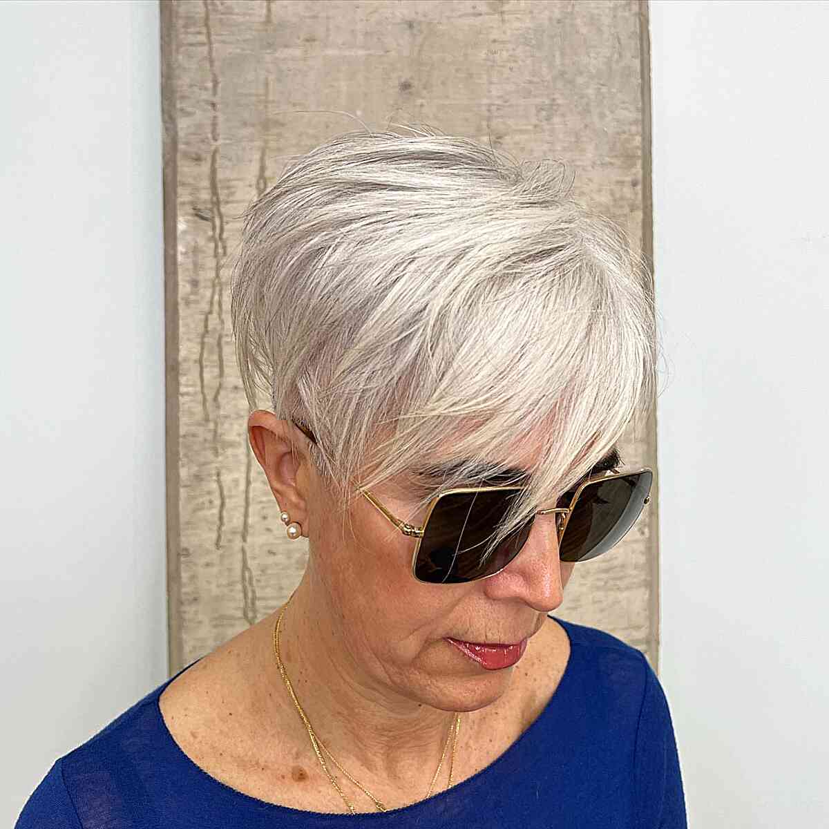 Platinum pixie with sweeping fringe and tapered sides.