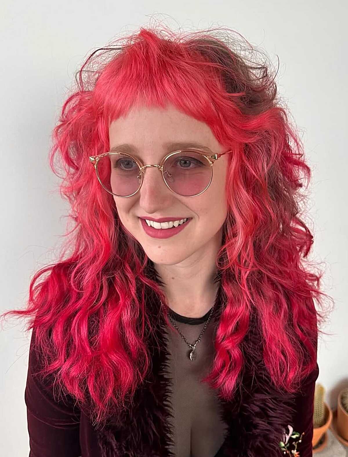 Hot pink wavy shag with volume and short fringe.