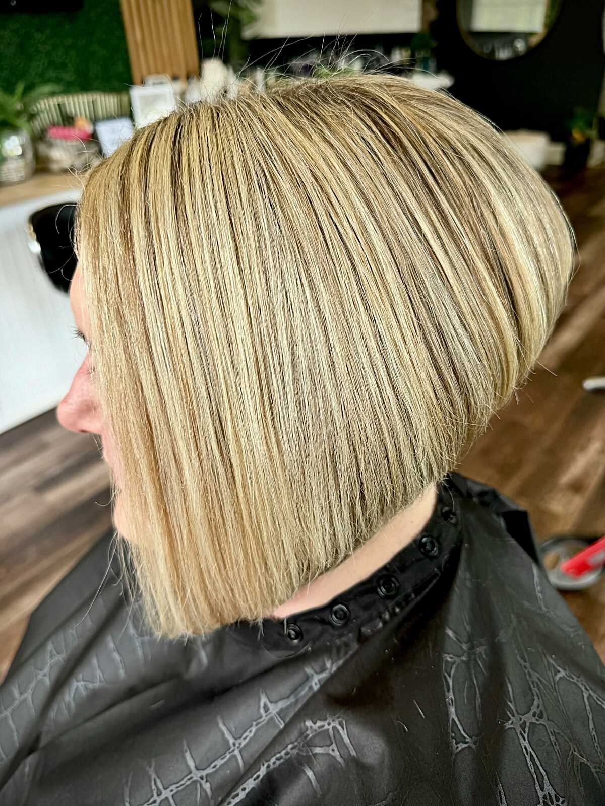 Blonde angled bob with soft graduation and smooth sides.
