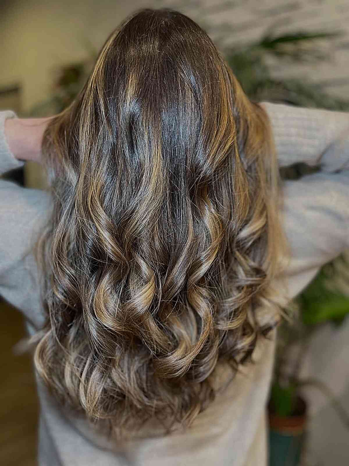 Long wavy hair with subtle highlights and a smooth crown.
