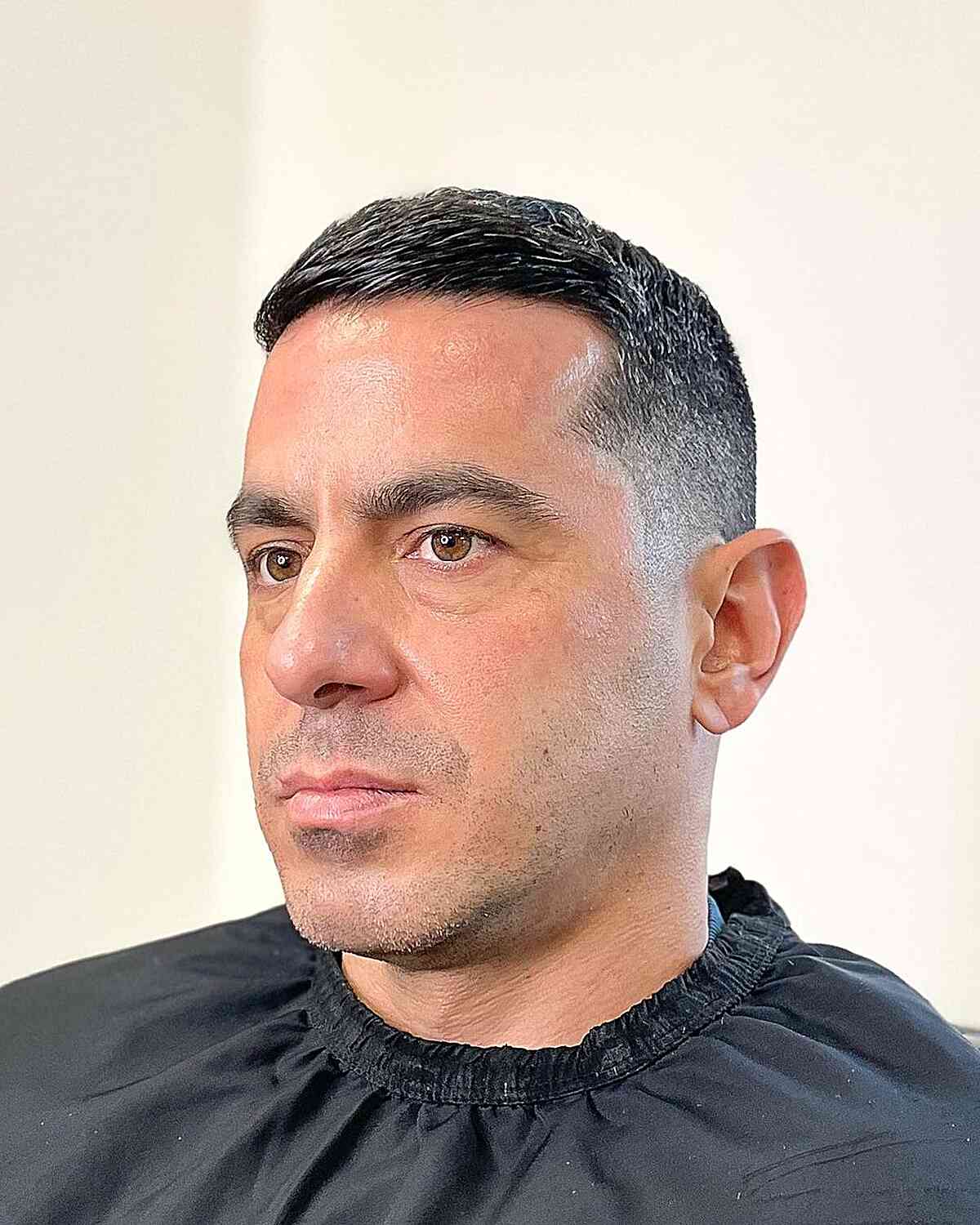 Very short slicked crew cut with close faded sides.