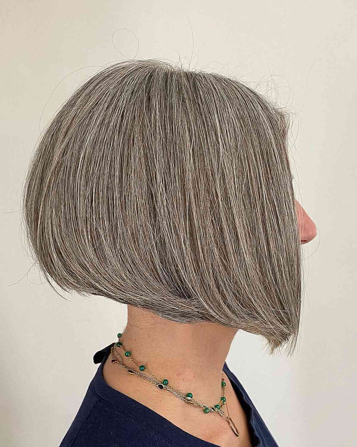 Silver-toned angled bob with a beveled edge and smooth finish.