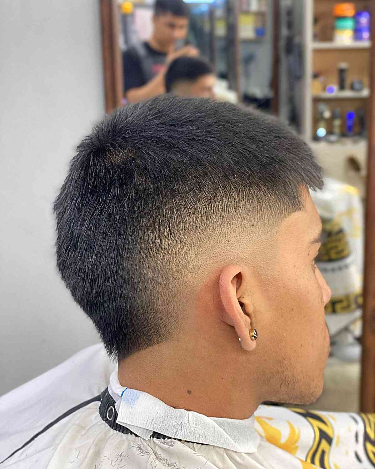 Very short crop with a burst fade around the ear and nape.