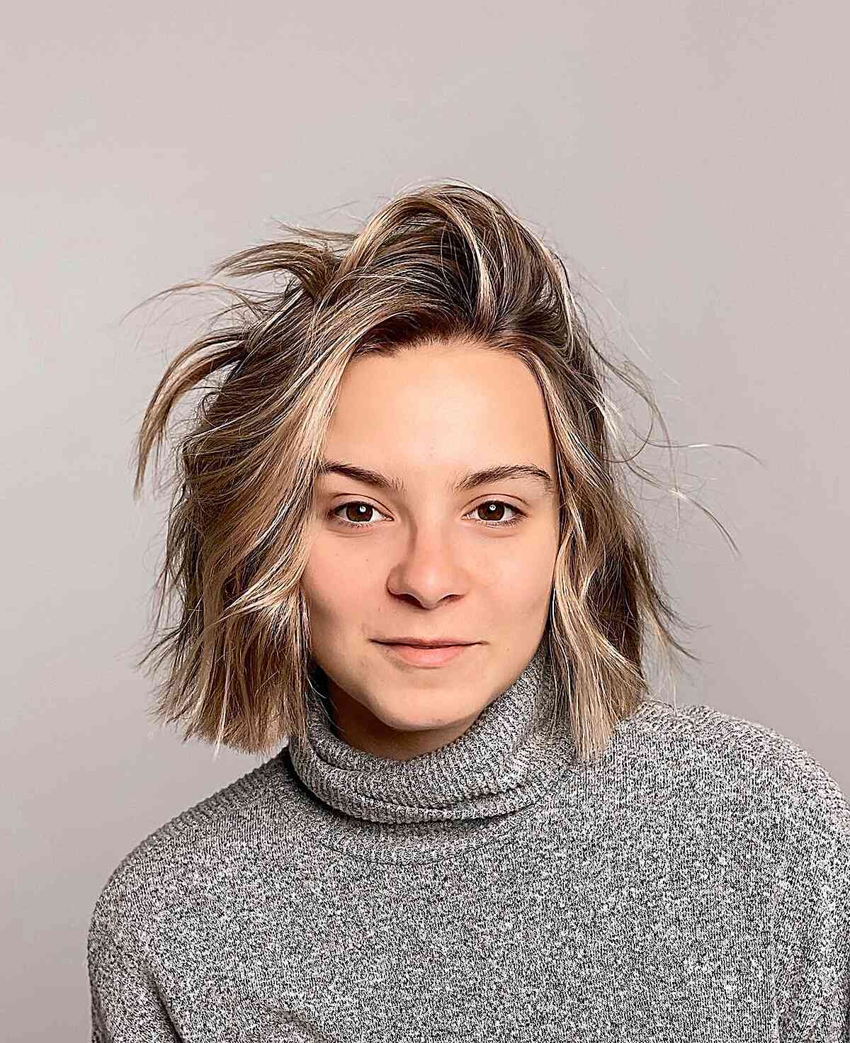 Short inverted bob with bronde highlights and textured ends