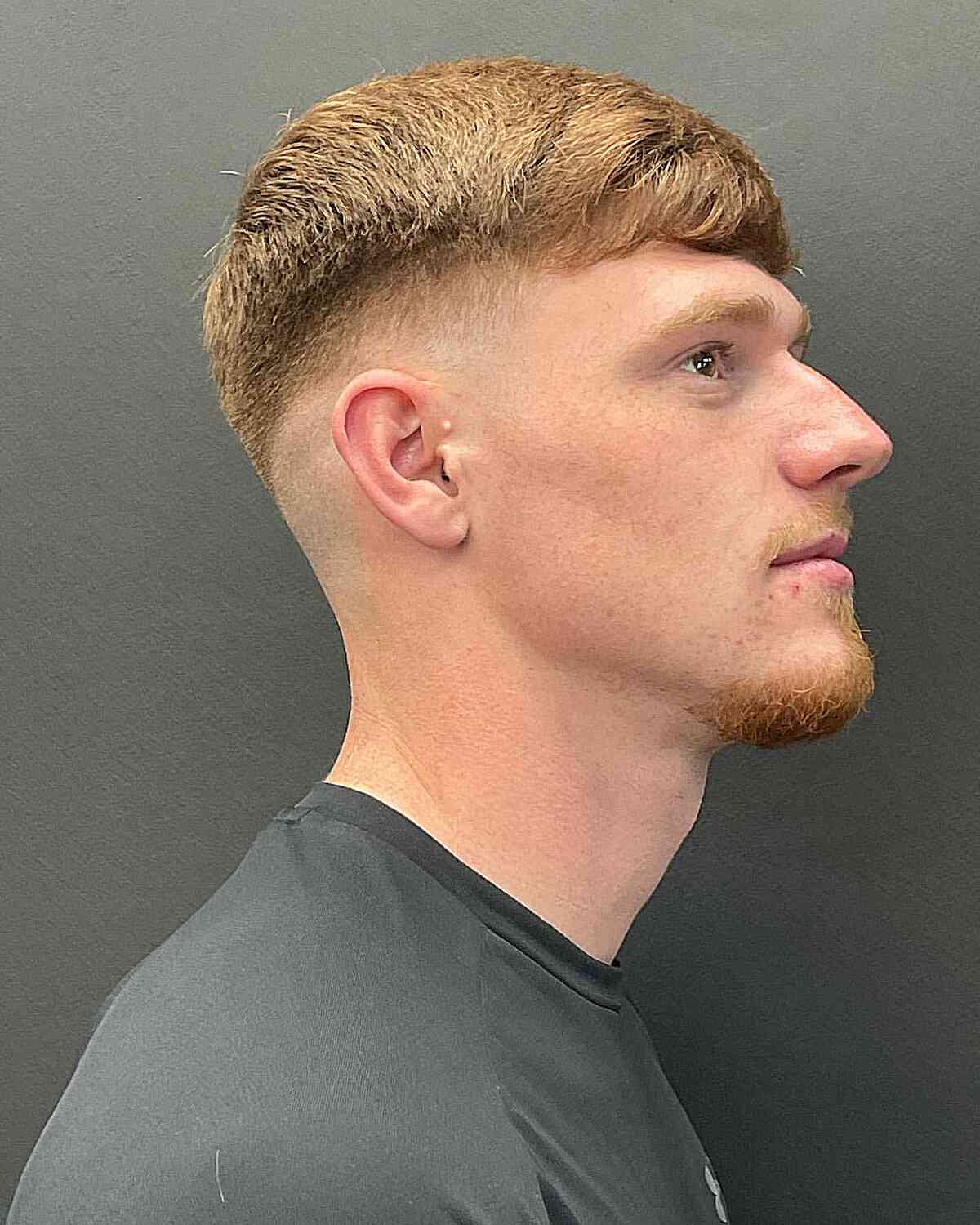 Short textured fringe with a low top and faded sides.