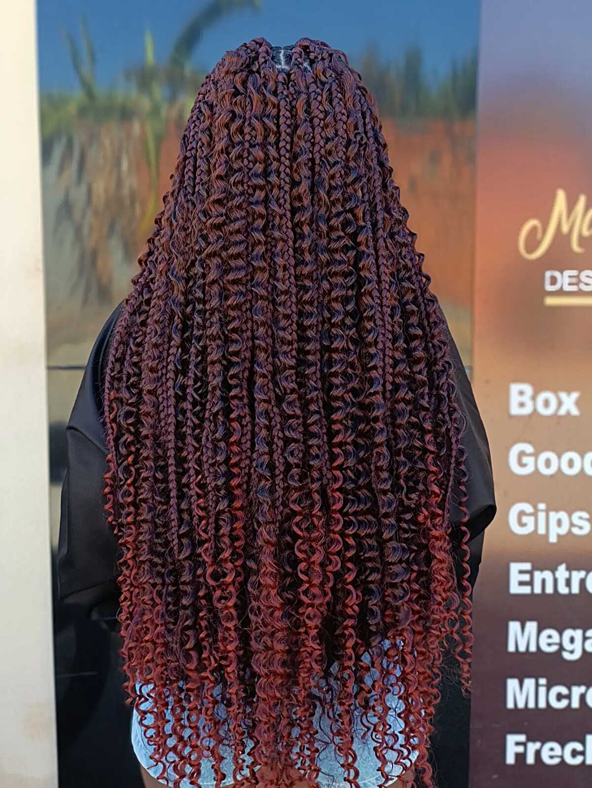 Deep burgundy box braids with curly extensions through the length