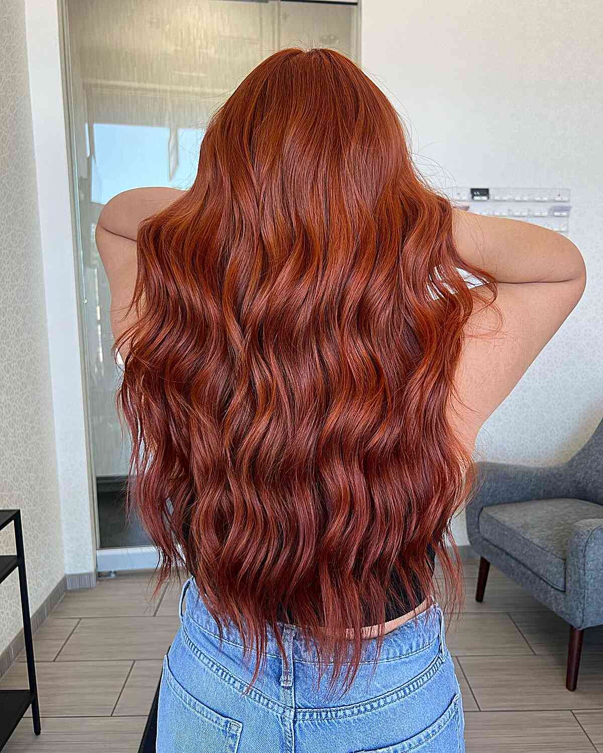 Long copper-red waves with a glossy finish and soft tapering ends.
