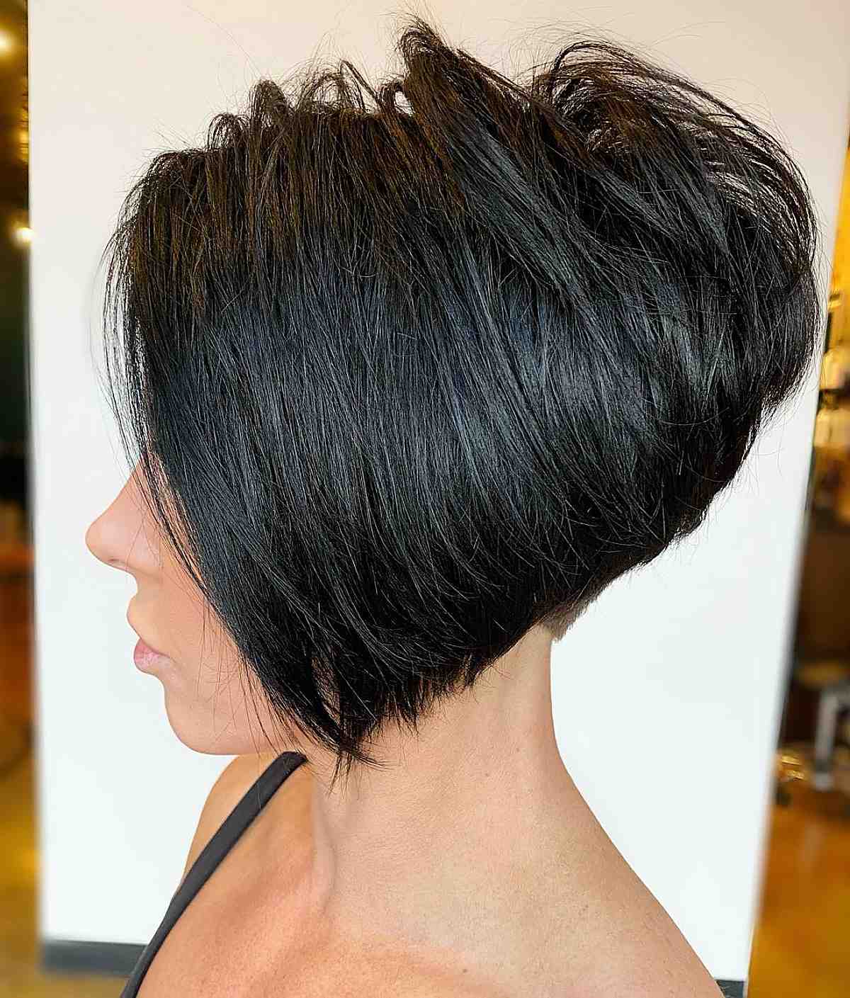 Dark angled bob with a stacked back and long front section.