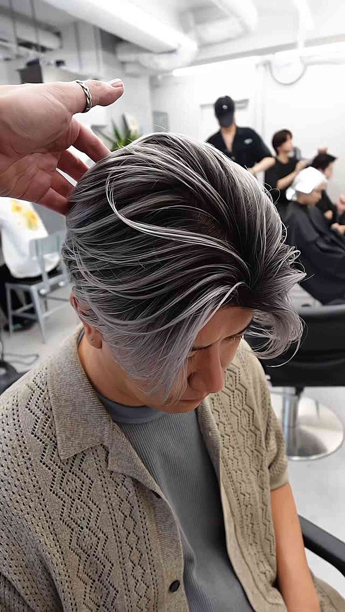 Long layered silver-and-dark swept hairstyle