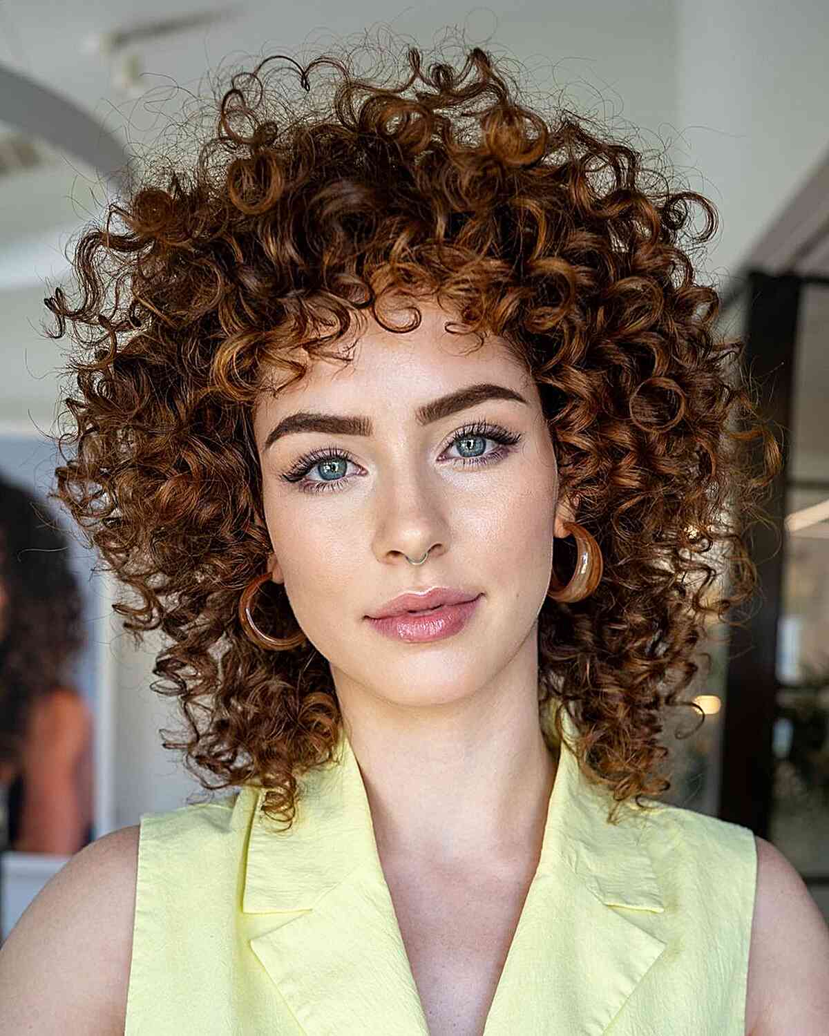 Copper-brown spiral curls with a rounded outline and curly fringe.