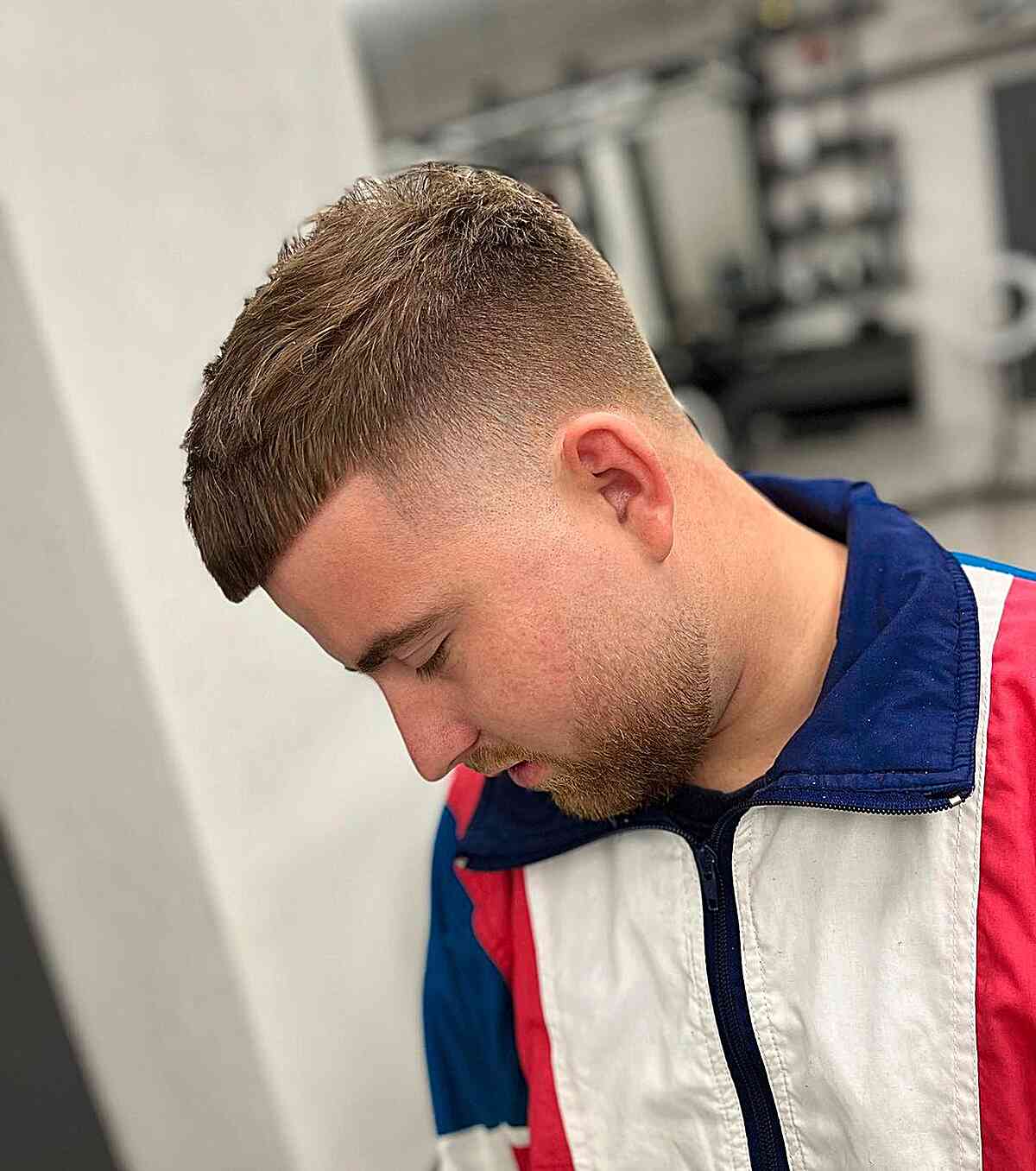 Short blunt fringe with a close skin fade and textured top.