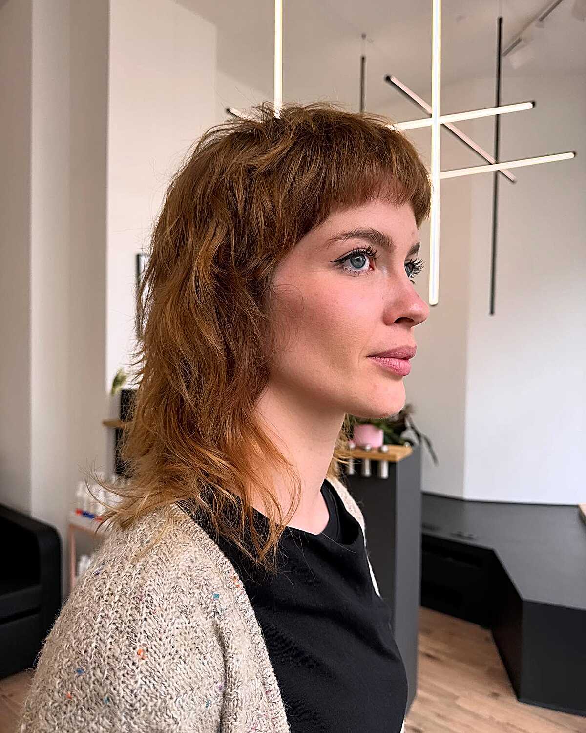 Warm auburn shag with baby bangs and layered, flipped ends.