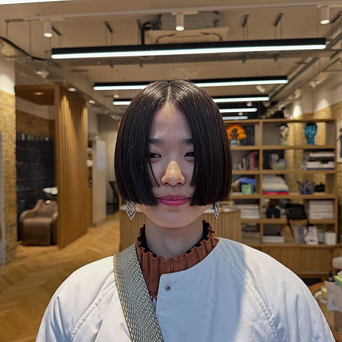 Jaw-length black bob with a thin see-through fringe and blunt ends.