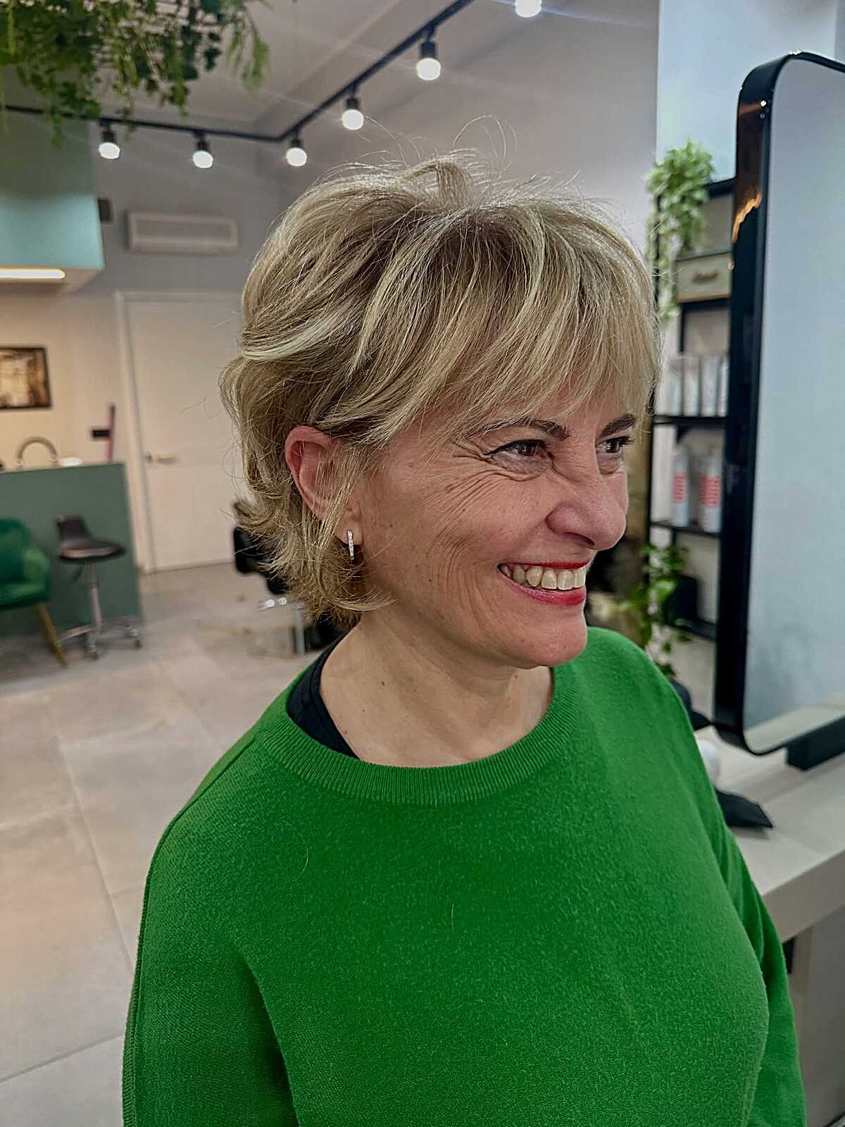 Blonde layered pixie with flipped ends and fringe.