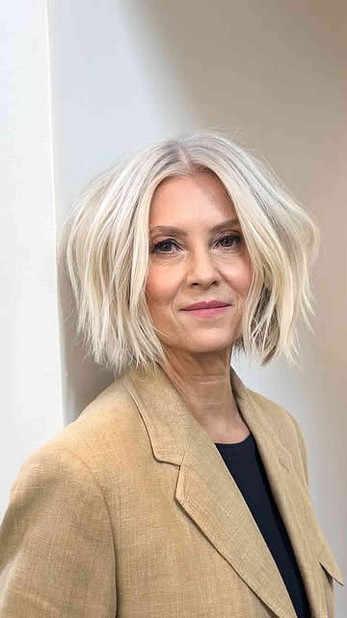 Chin-length bob with soft waves and a center part.