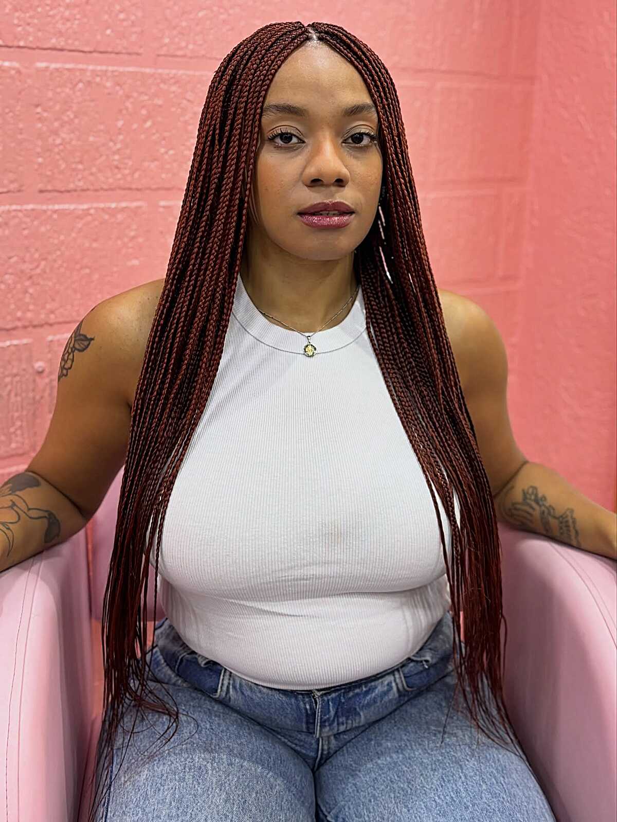 Long small burgundy box braids past the waist