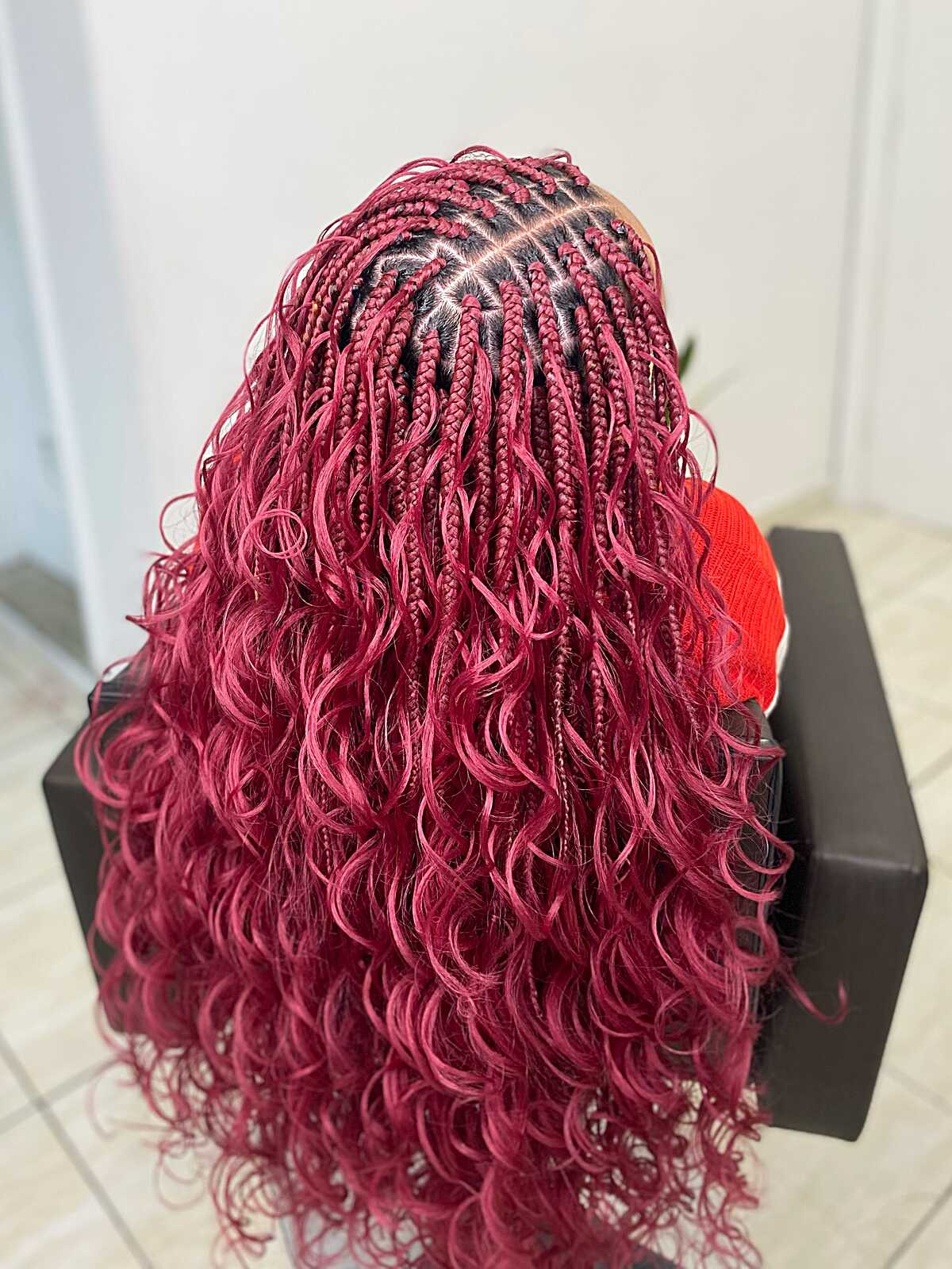 Bright burgundy knotless braids with wavy texture