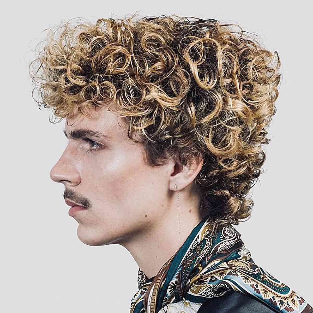 Curly mullet with blonde highlights and longer back