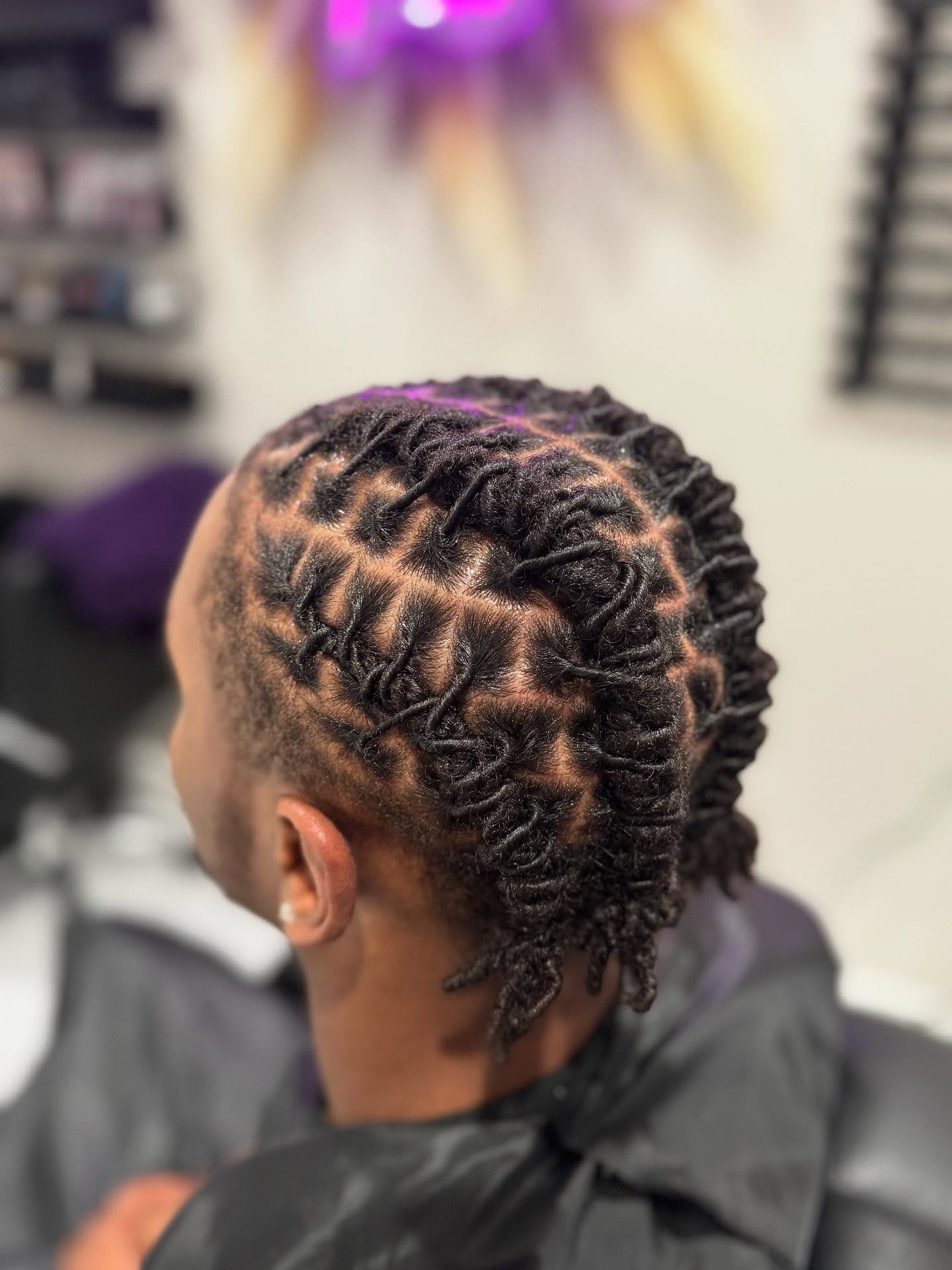 Close dread style with curved parting patterns across the scalp.