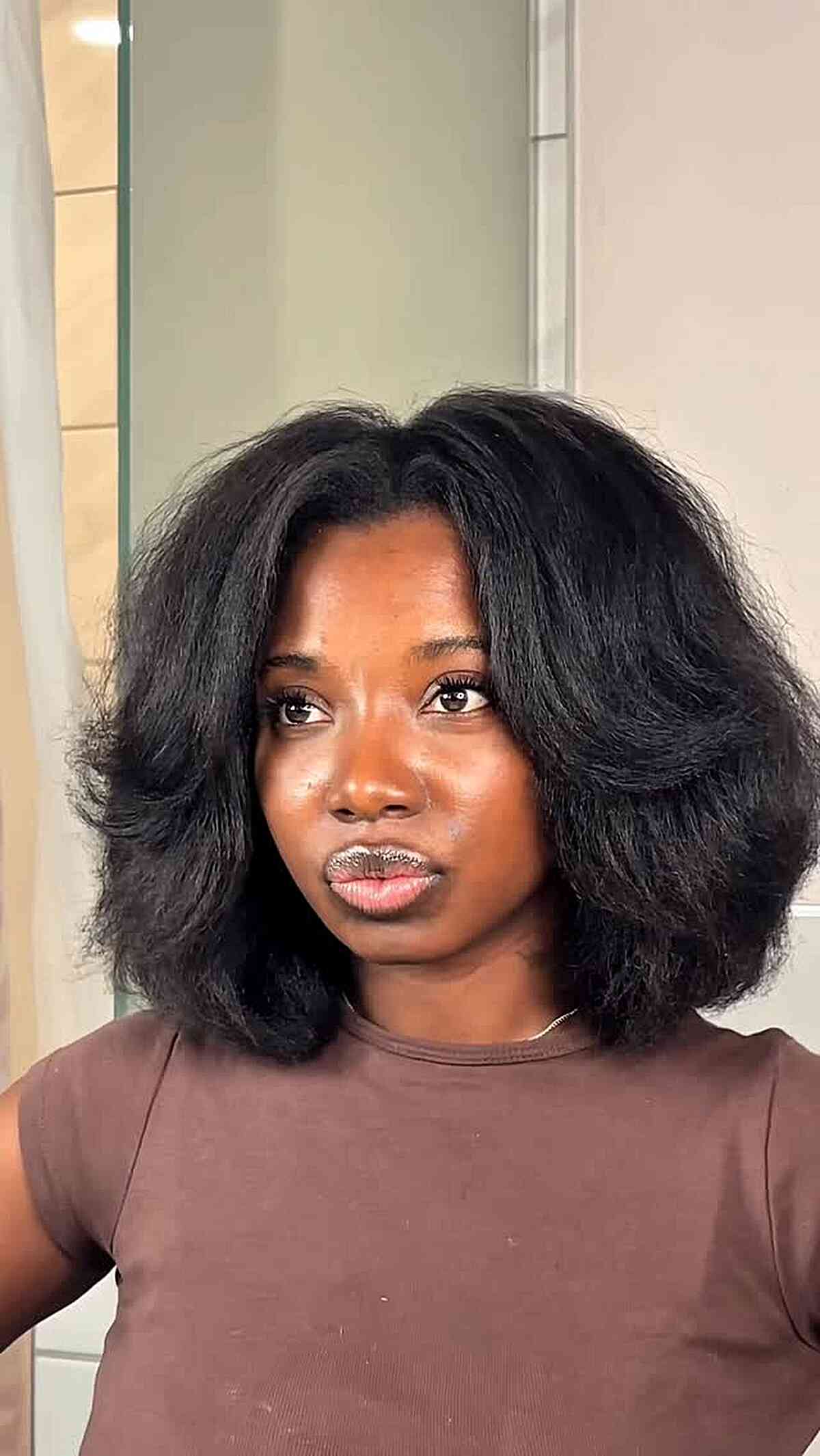 Layered jaw-length bob with voluminous blowout styling.