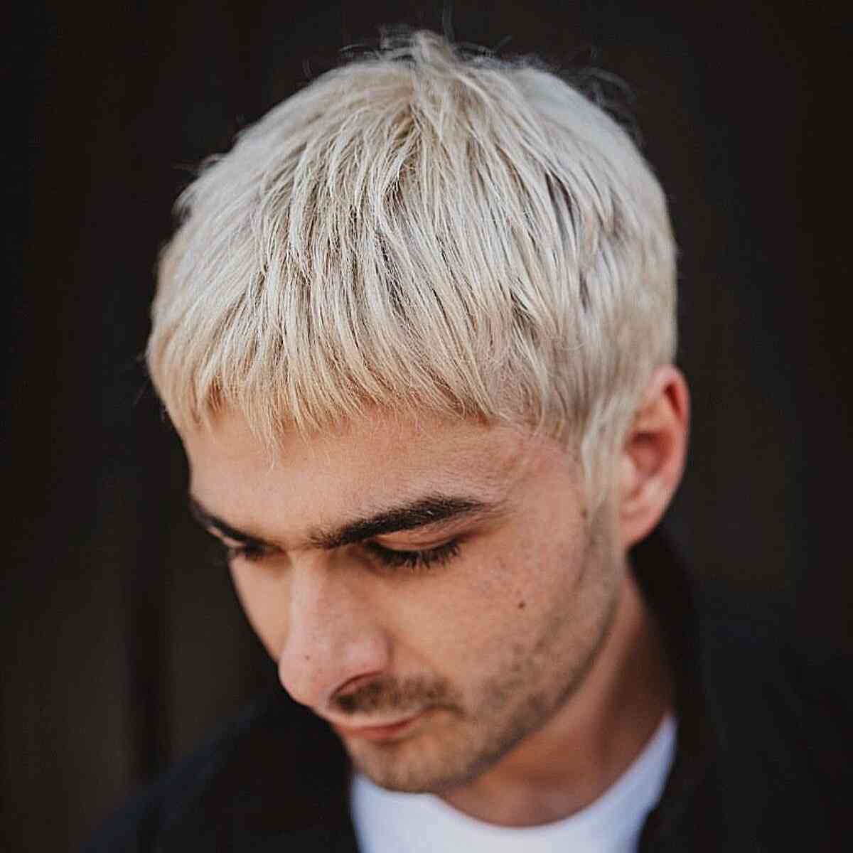 Platinum short hair with cropped bangs and a textured top.