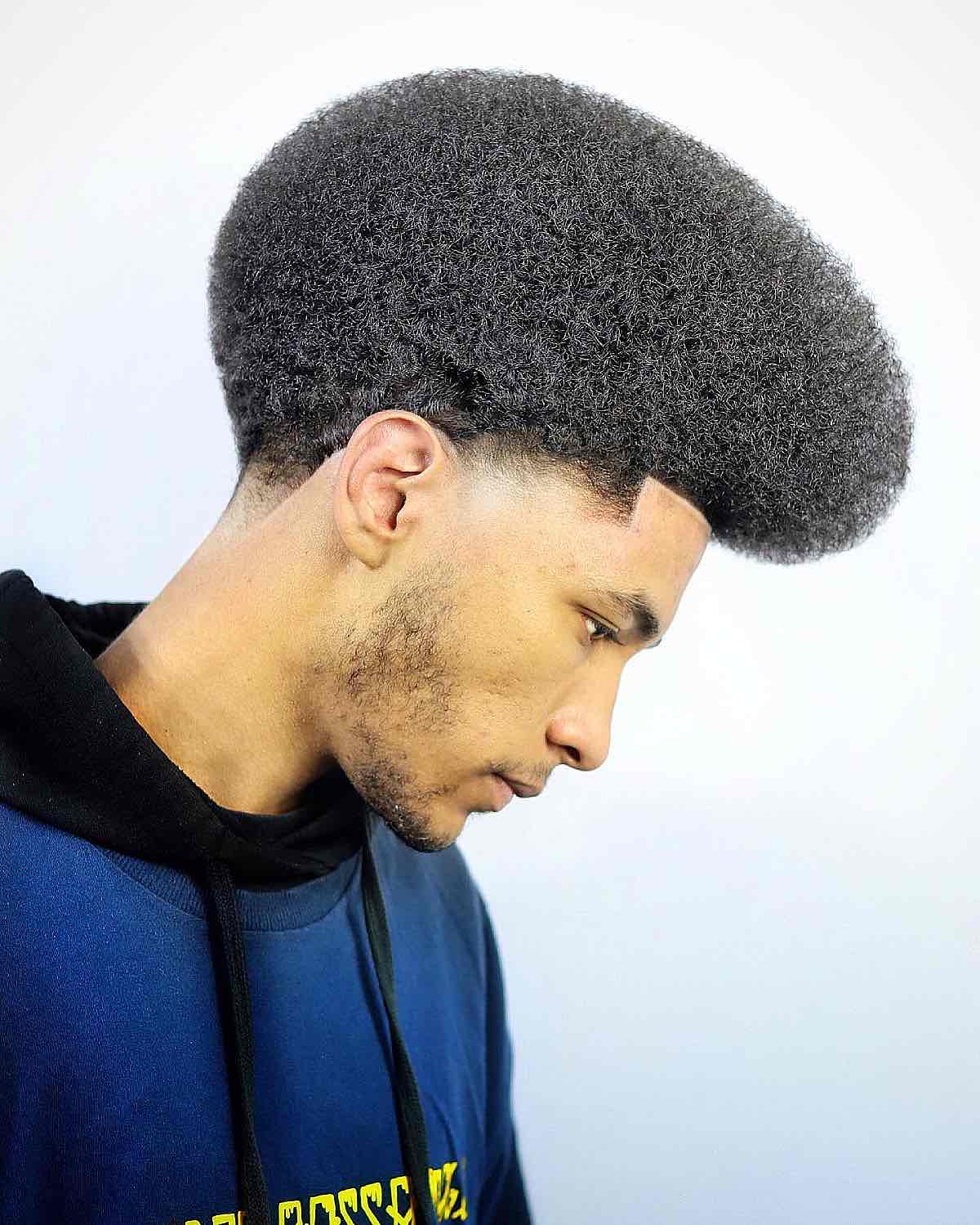 Large rounded afro with dense texture and a clean lower edge.
