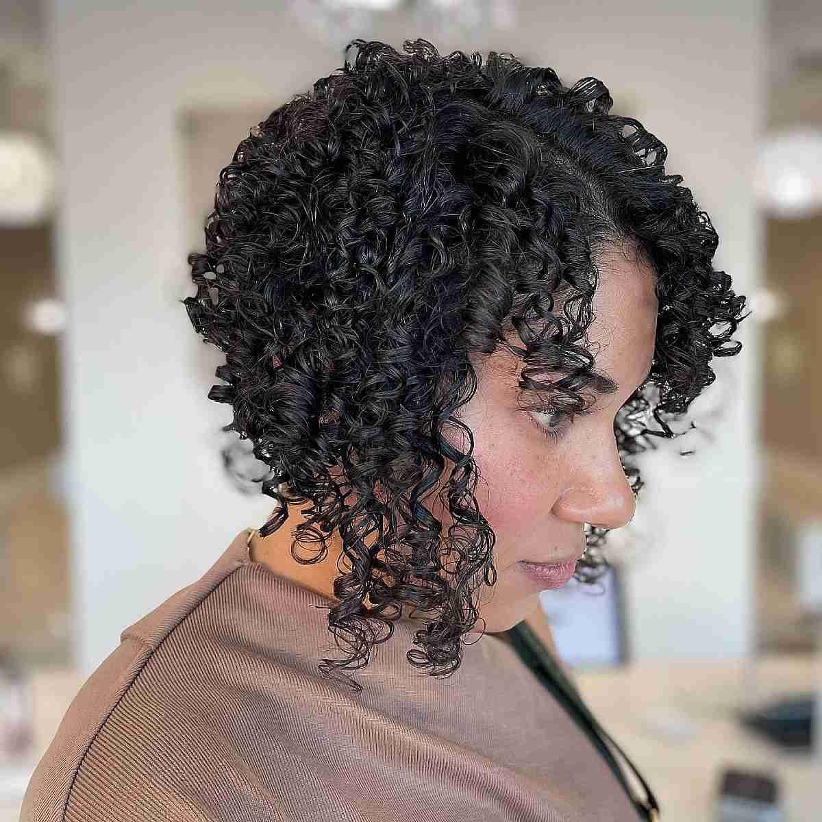 Curly angled bob with a tapered back and forward curls.